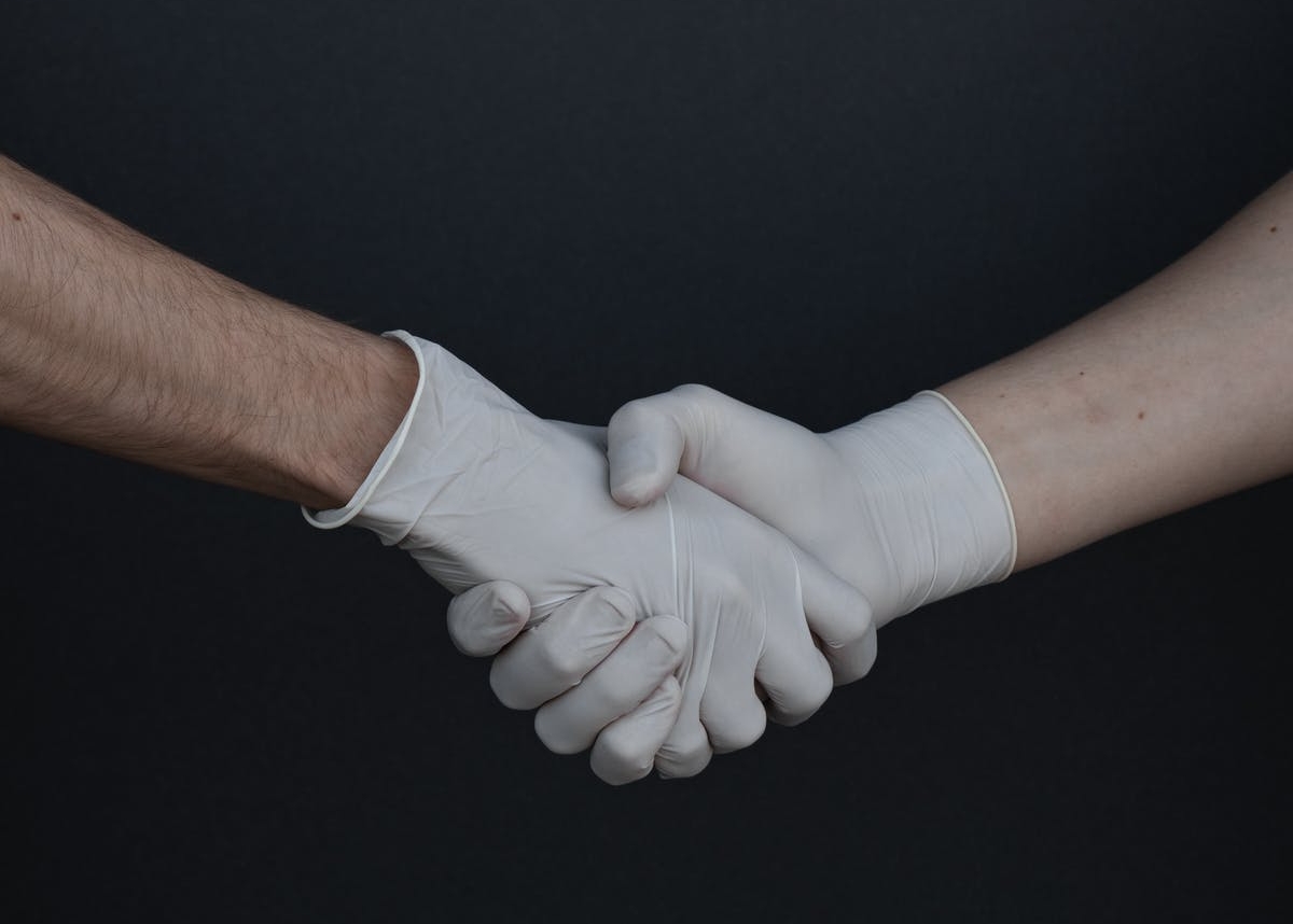 Two gloved hands shaking