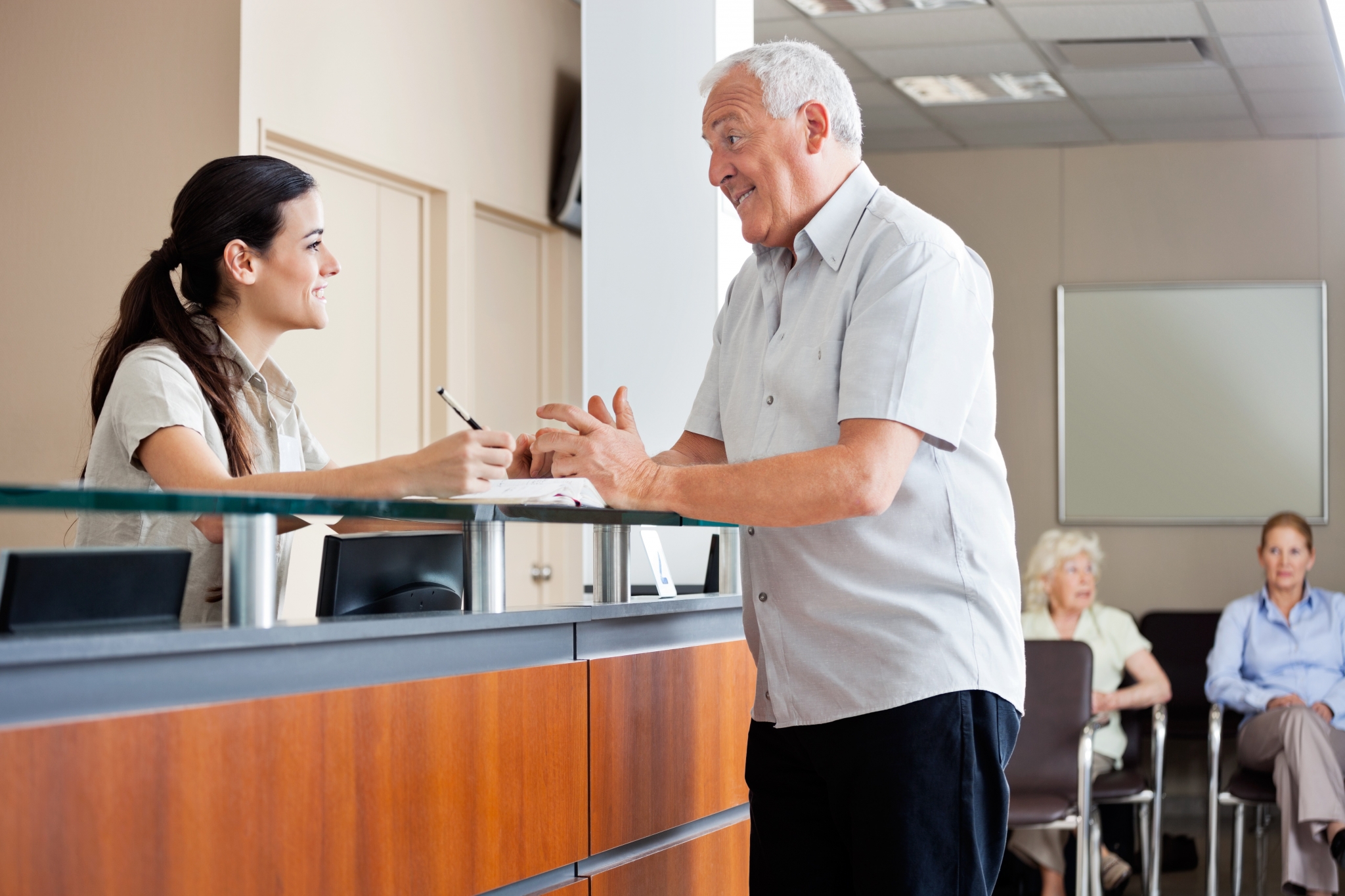 Receptionist helping a patient