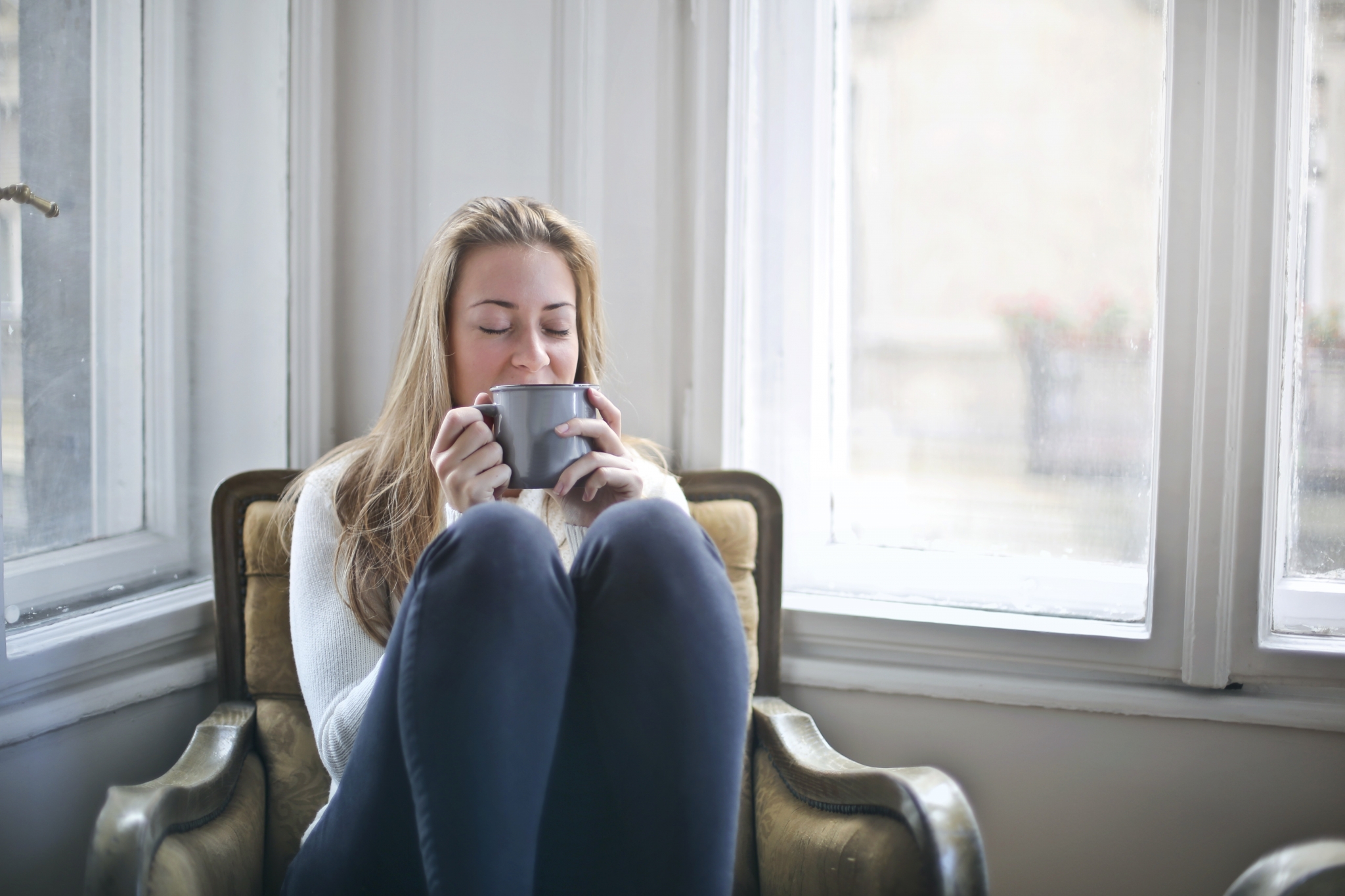 Woman holding gray ceramic mug