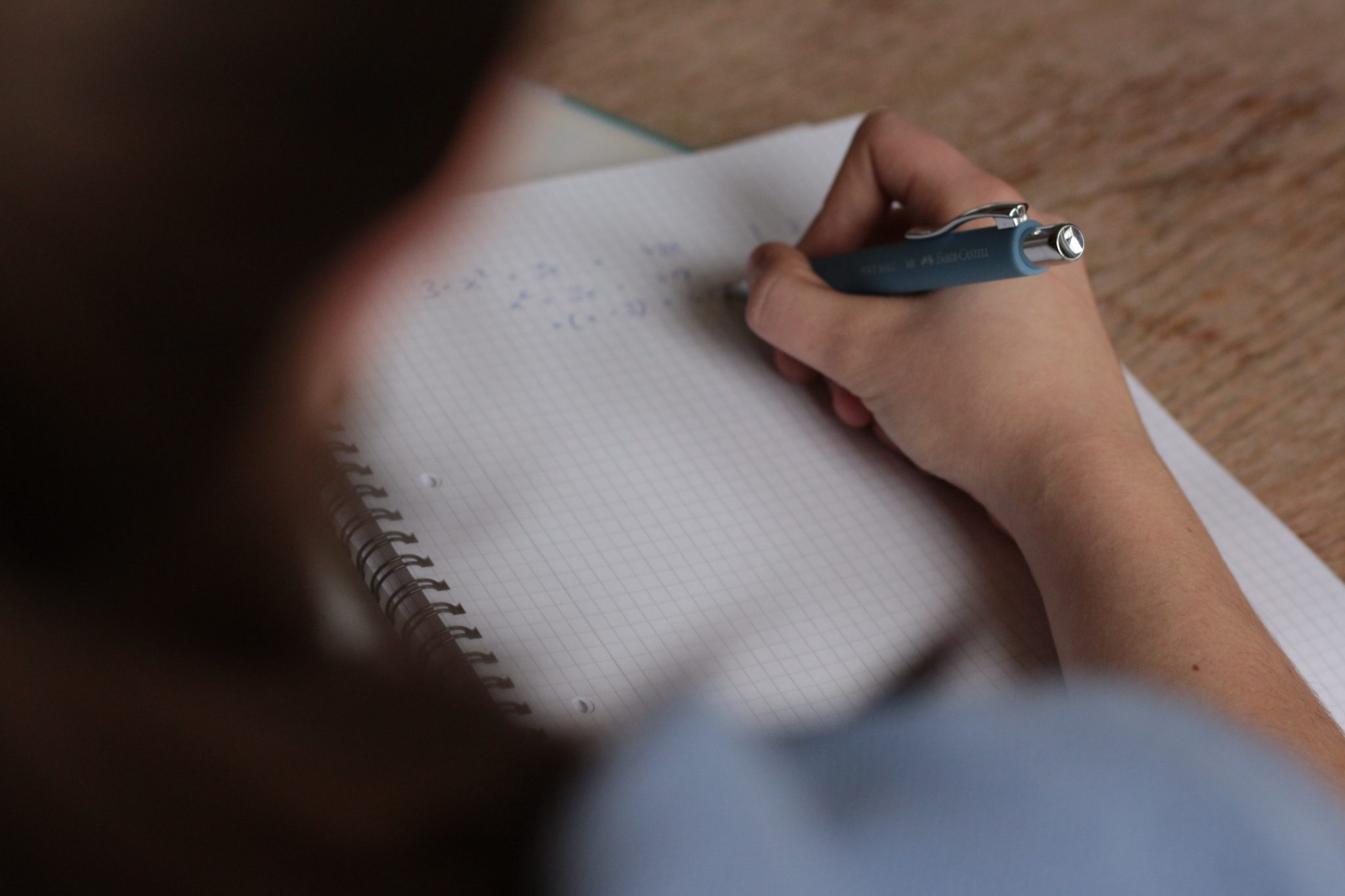 Female student writing on graph paper