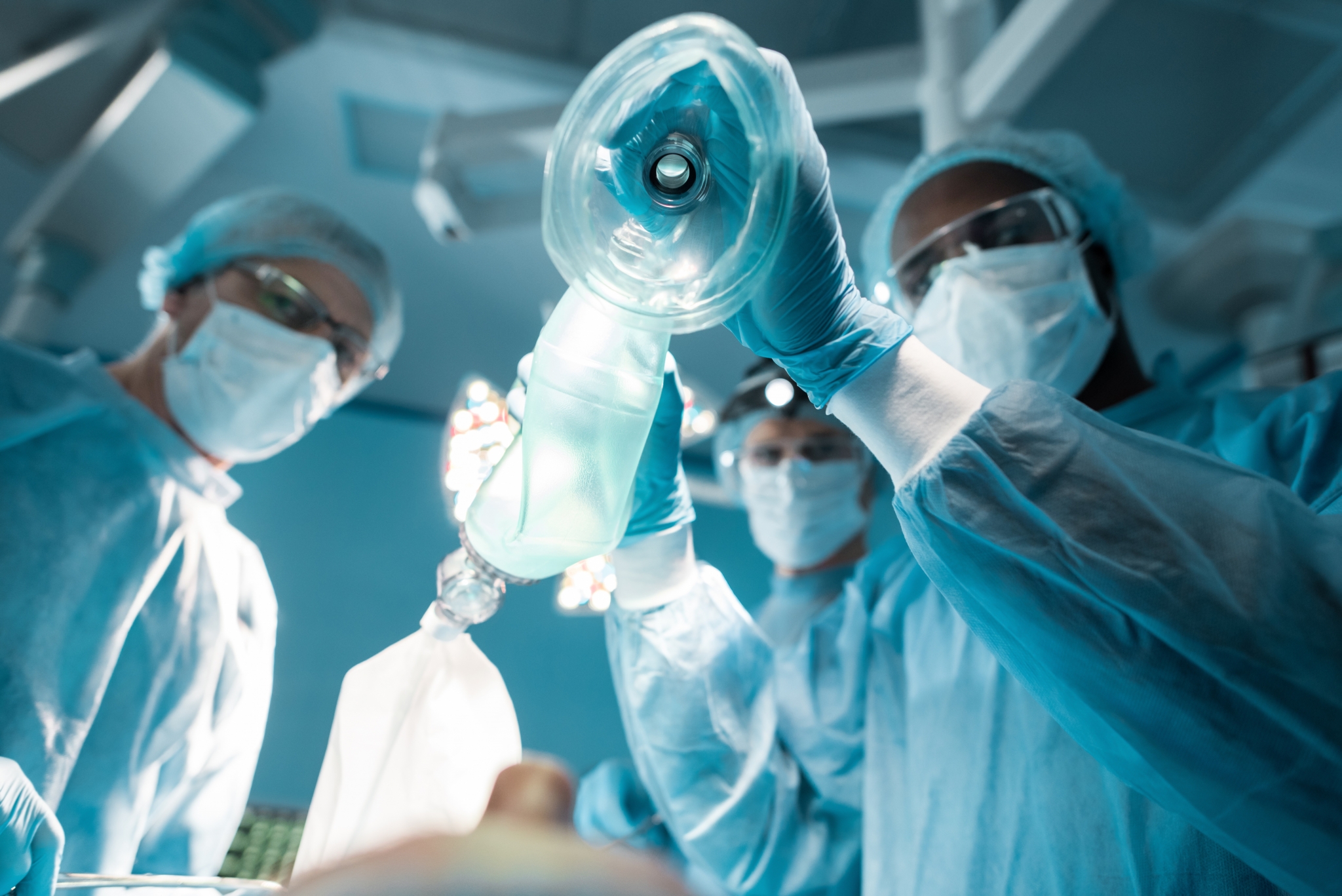 Operating room team administering anesthesia