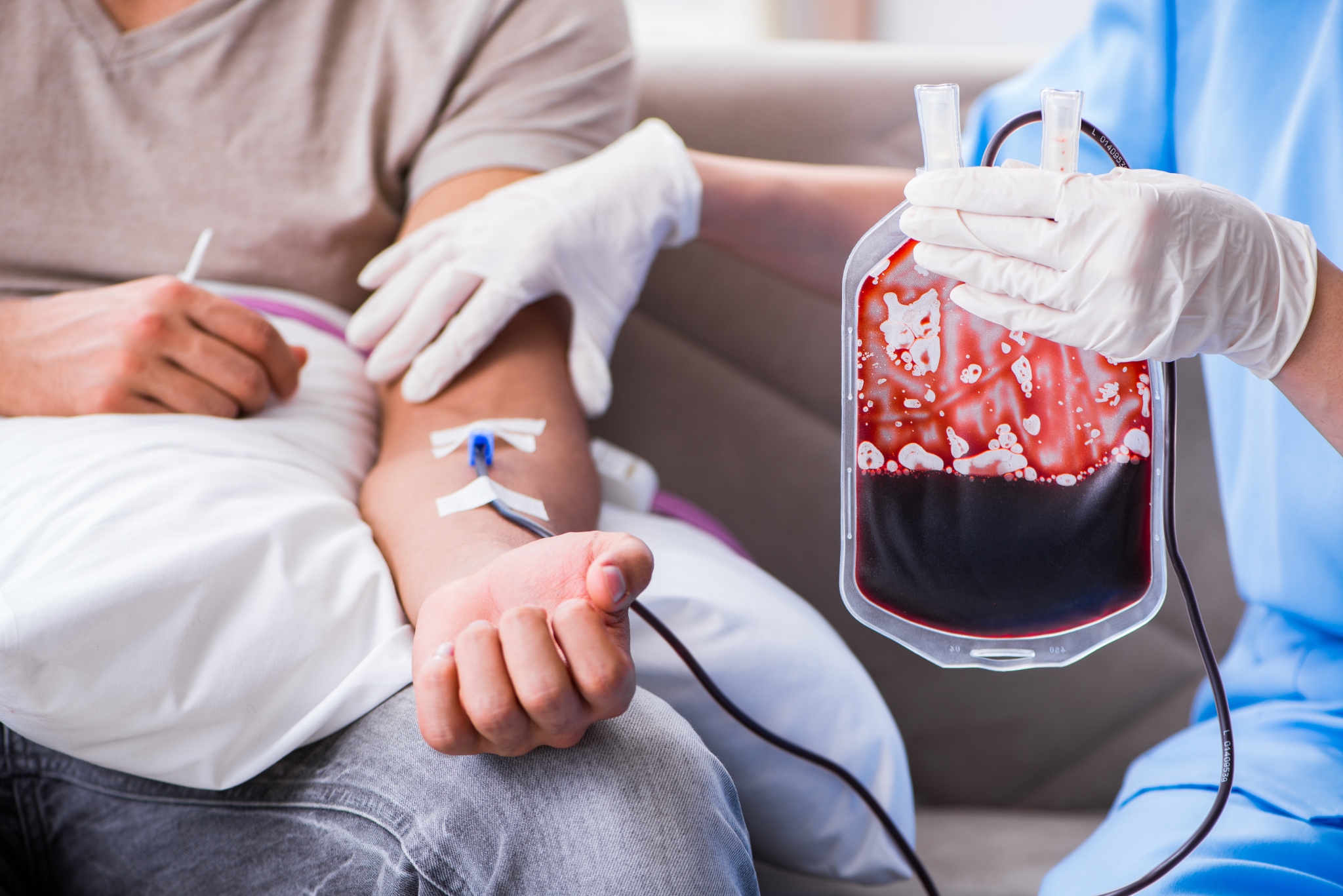 Nurse administering a blood transfusion.