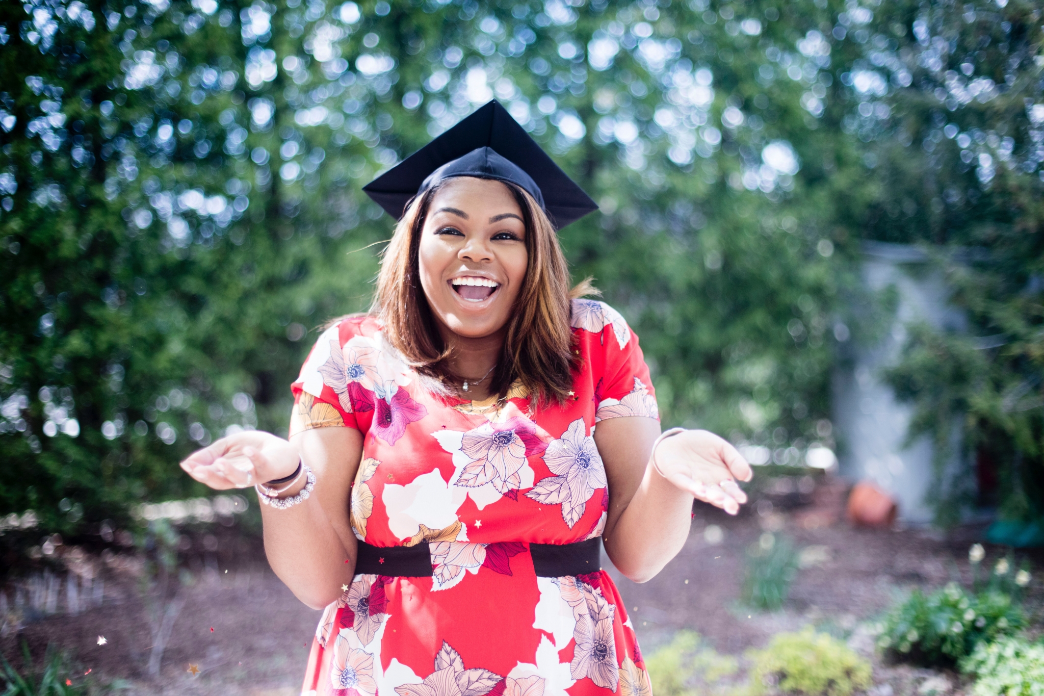 Smiling graduate in a garden