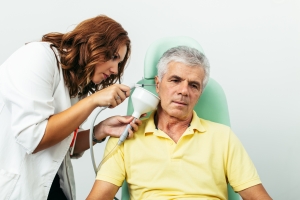 Nurse treating a patient's ear