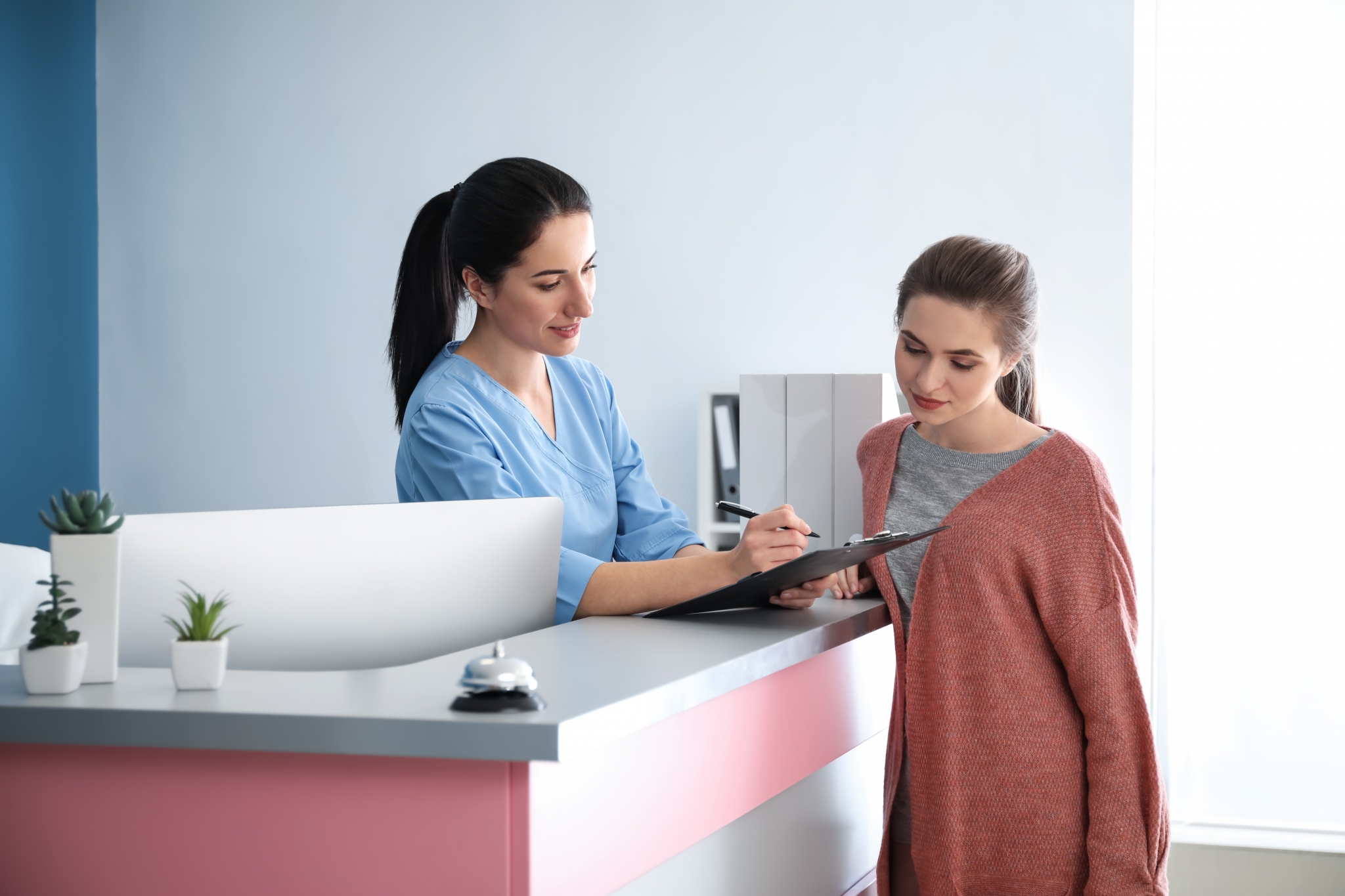 Medical receptionist helping a patient