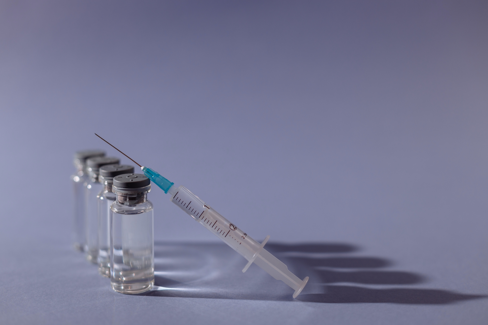 A syringe with a row of bottles