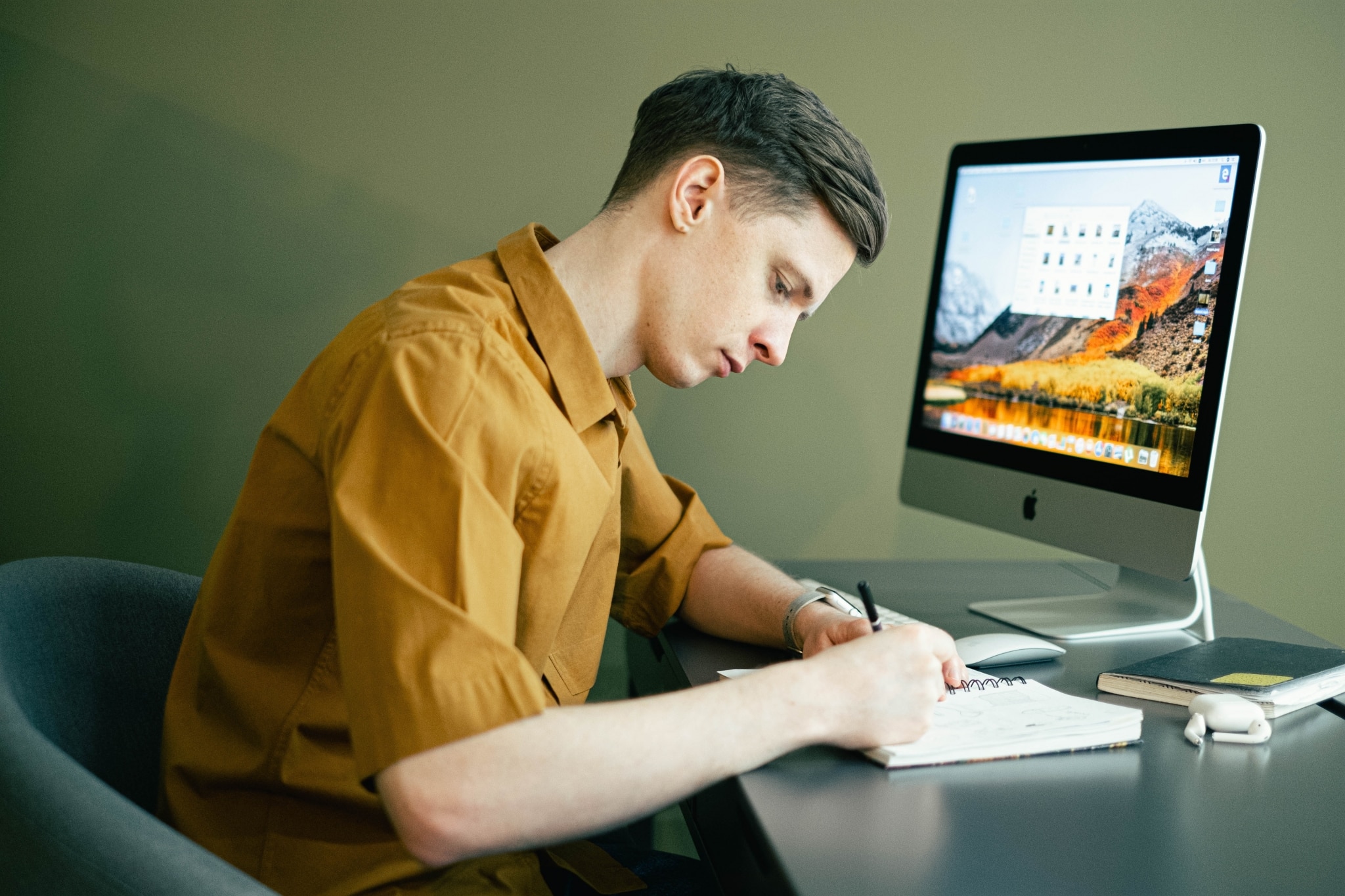 Man taking notes at his desk