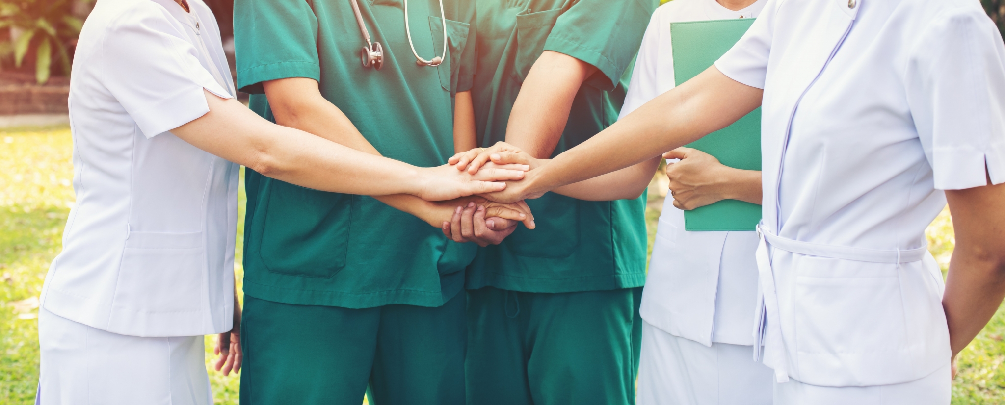 Medical professionals joining hands