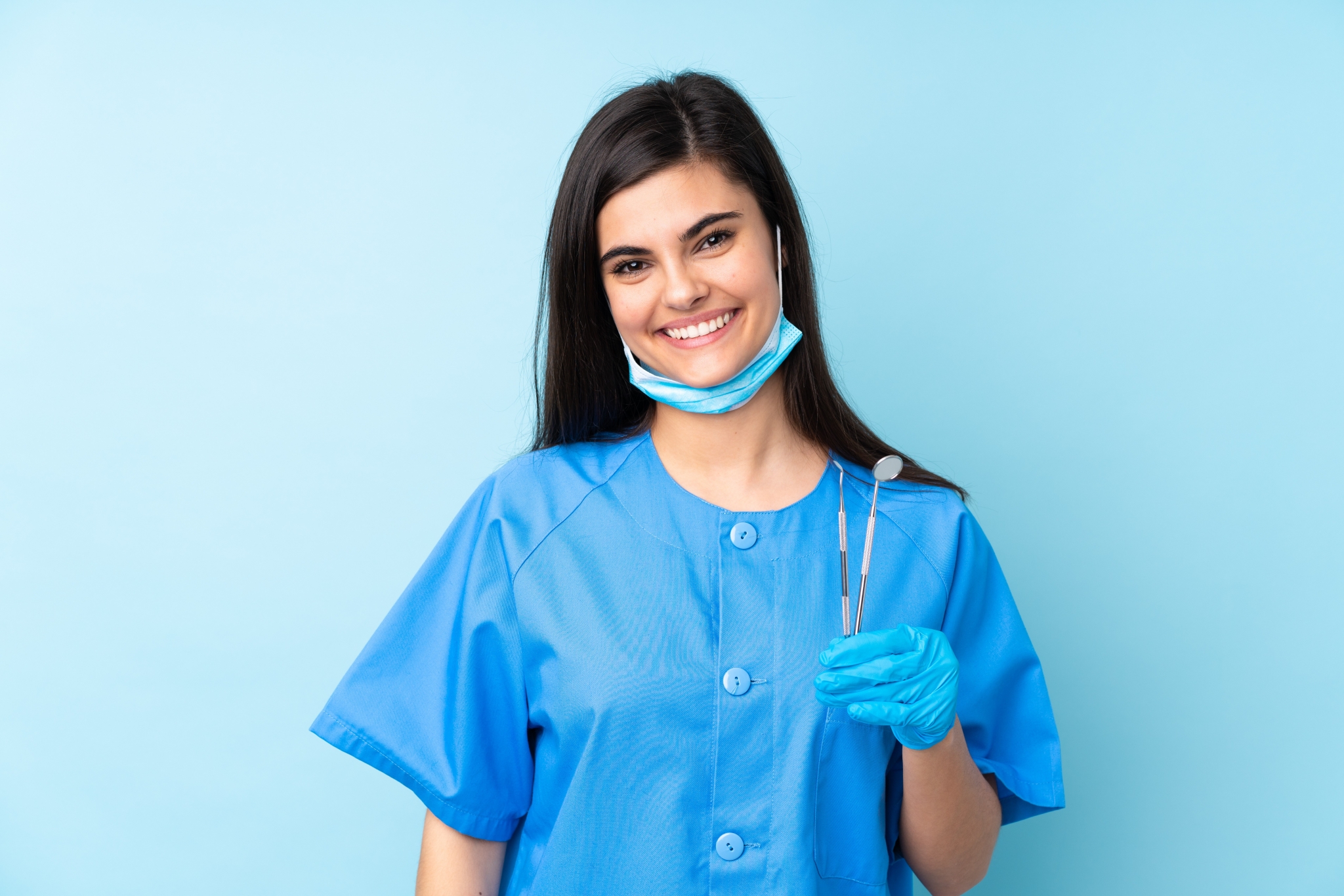 Young professional holding dental tools