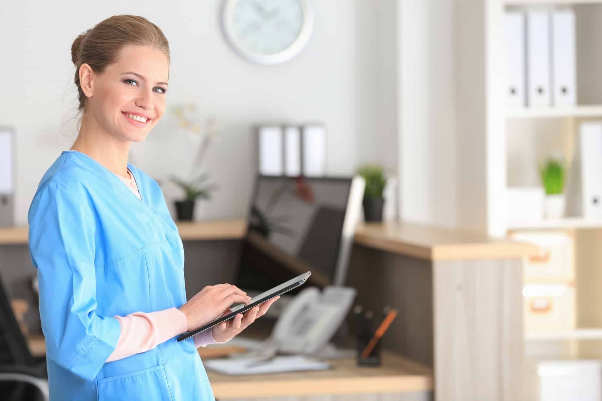 Female medical receptionist using a tablet