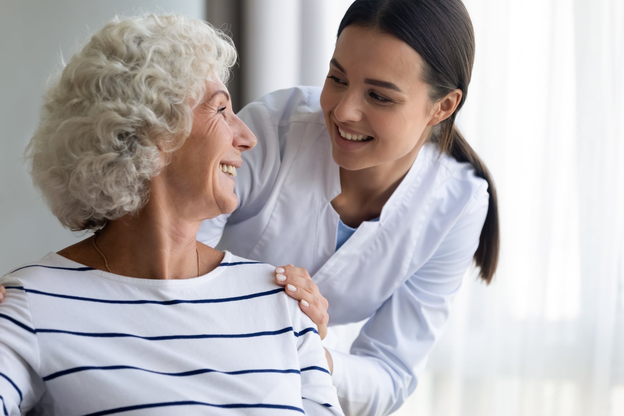 Caring young nurse with an elderly patient