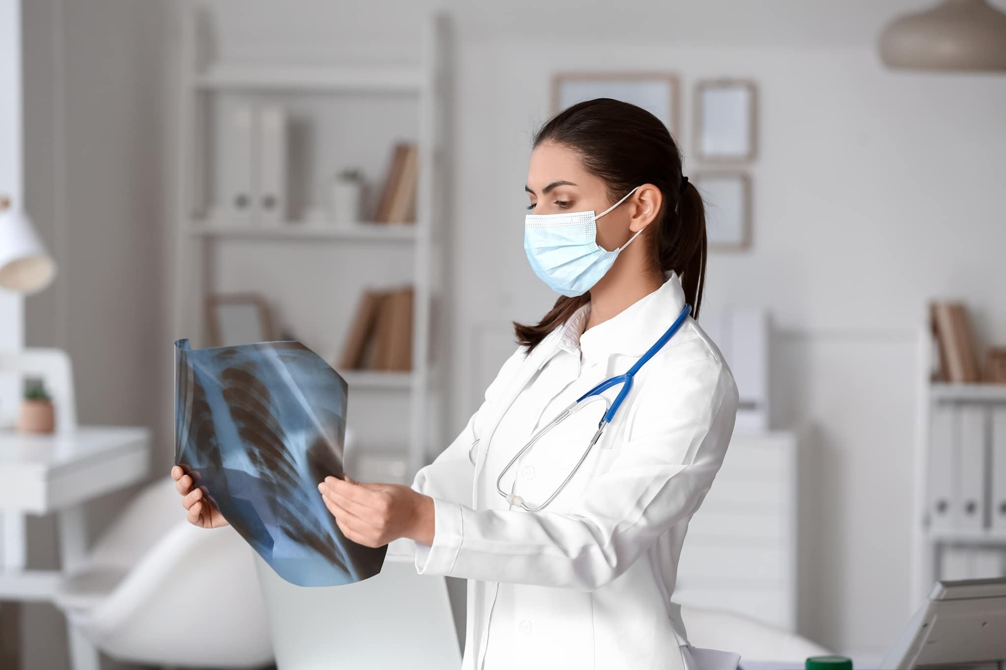 Female medical professional examining X-rays