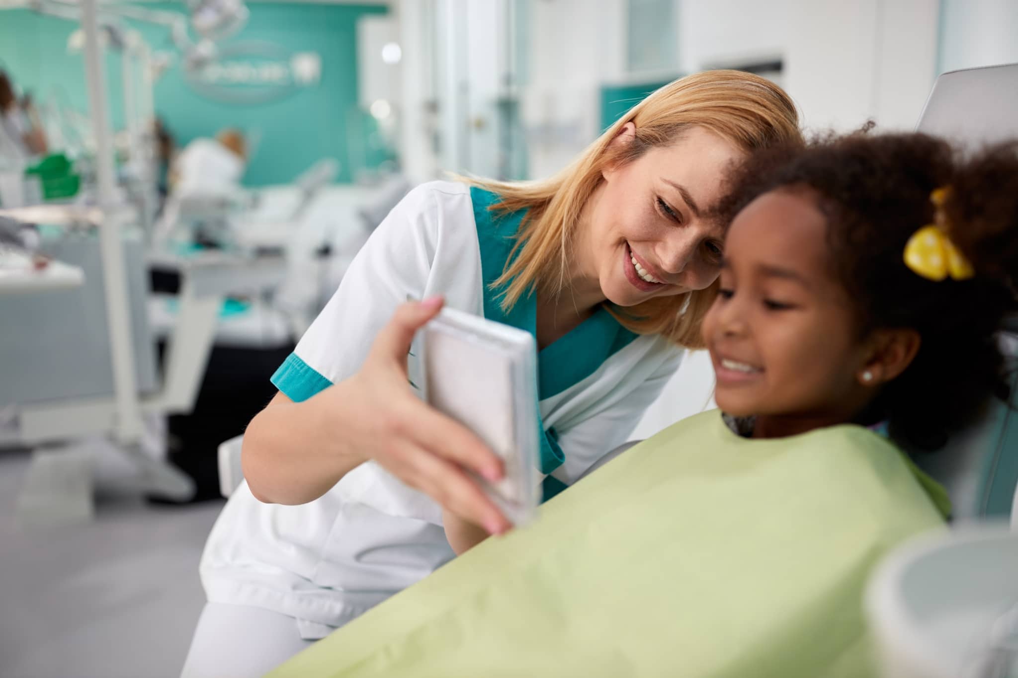 Dental Assistant holding a mirror for patient