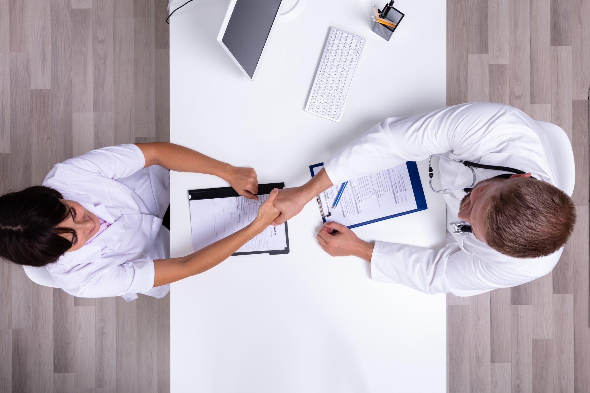 Overhead view of medical workers shaking hands