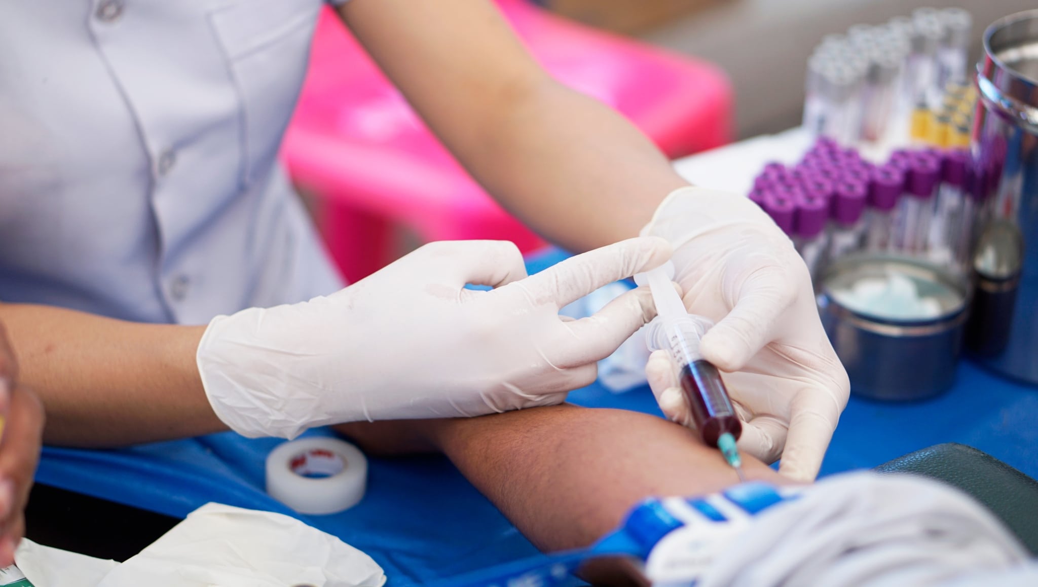 Medical professional drawing blood from a patient