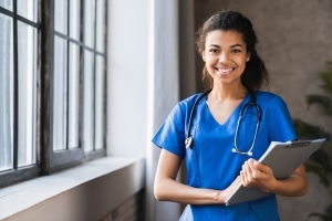 Smiling healthcare professional with clipboard