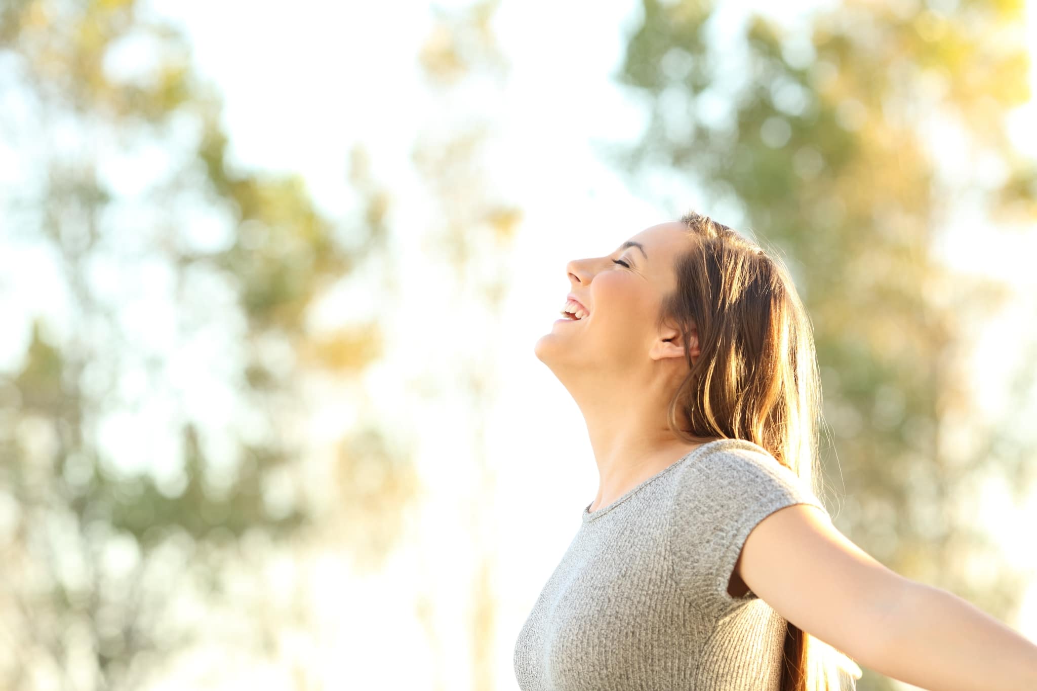 Side view of a smiling woman outside