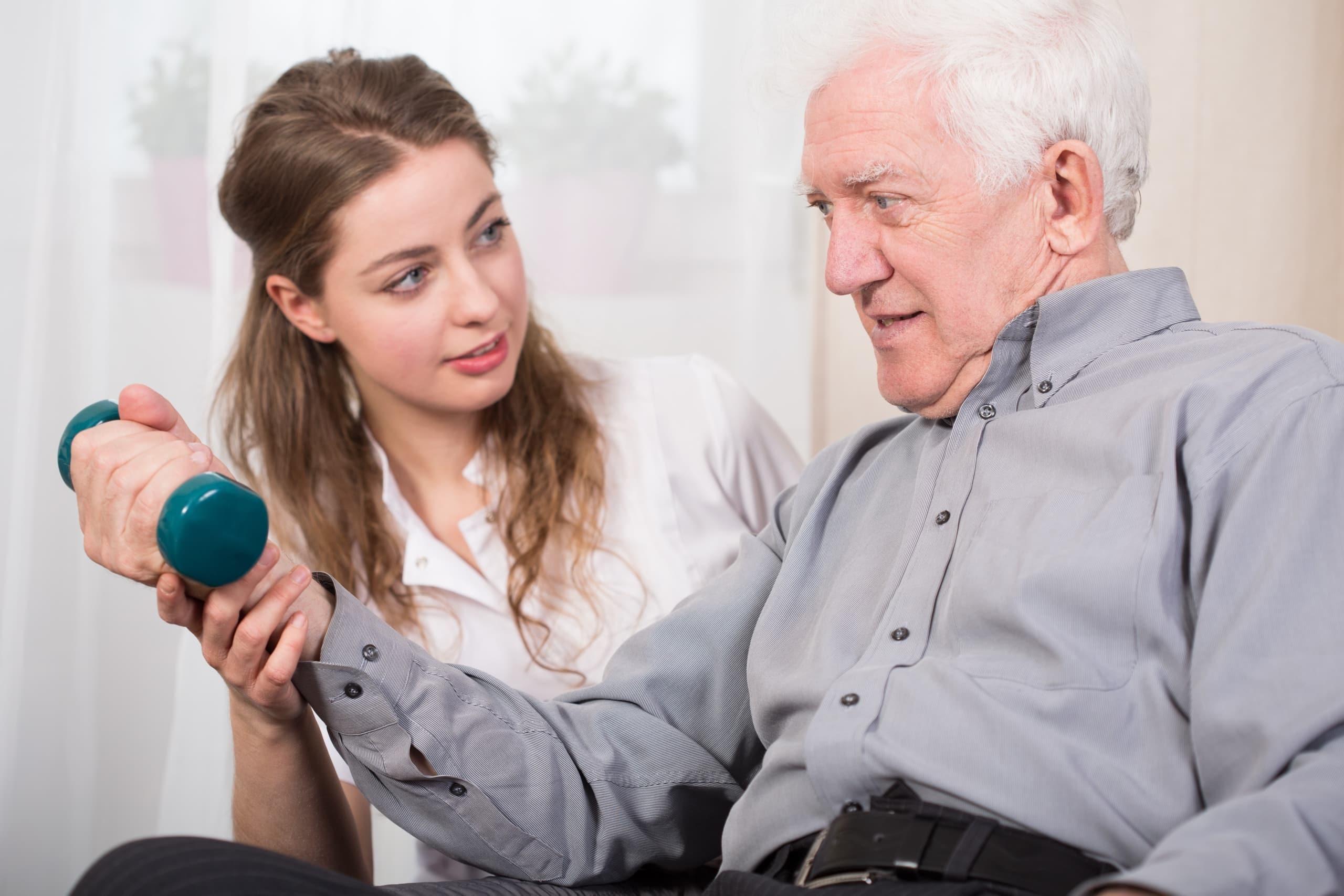 Physical therapist assistant with elderly man