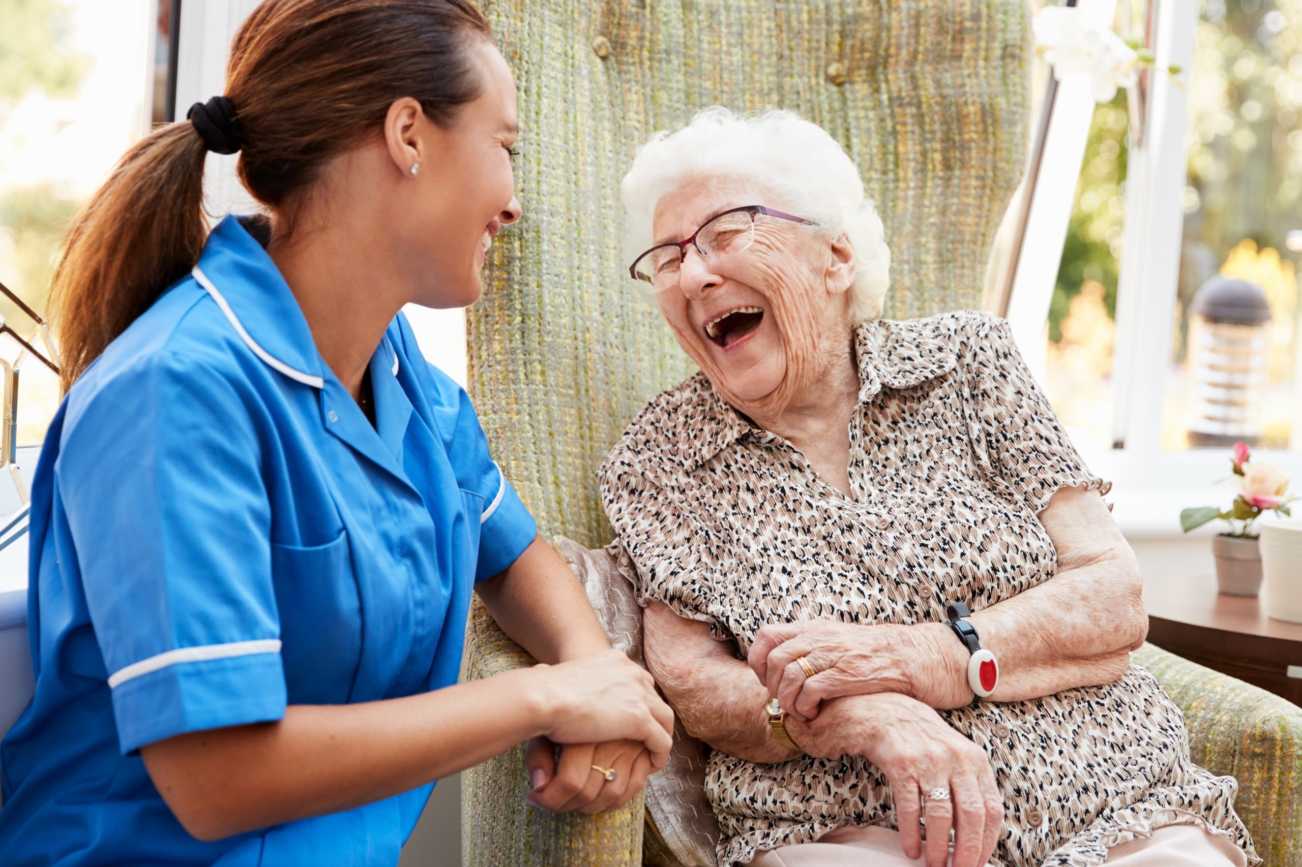 Senior woman laughing with a medical professional