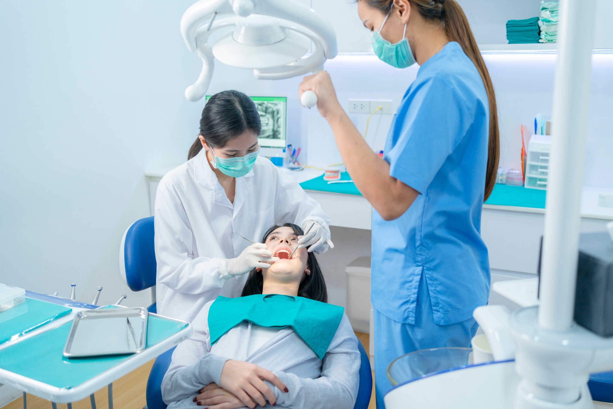 Female dental professionals examining a patient