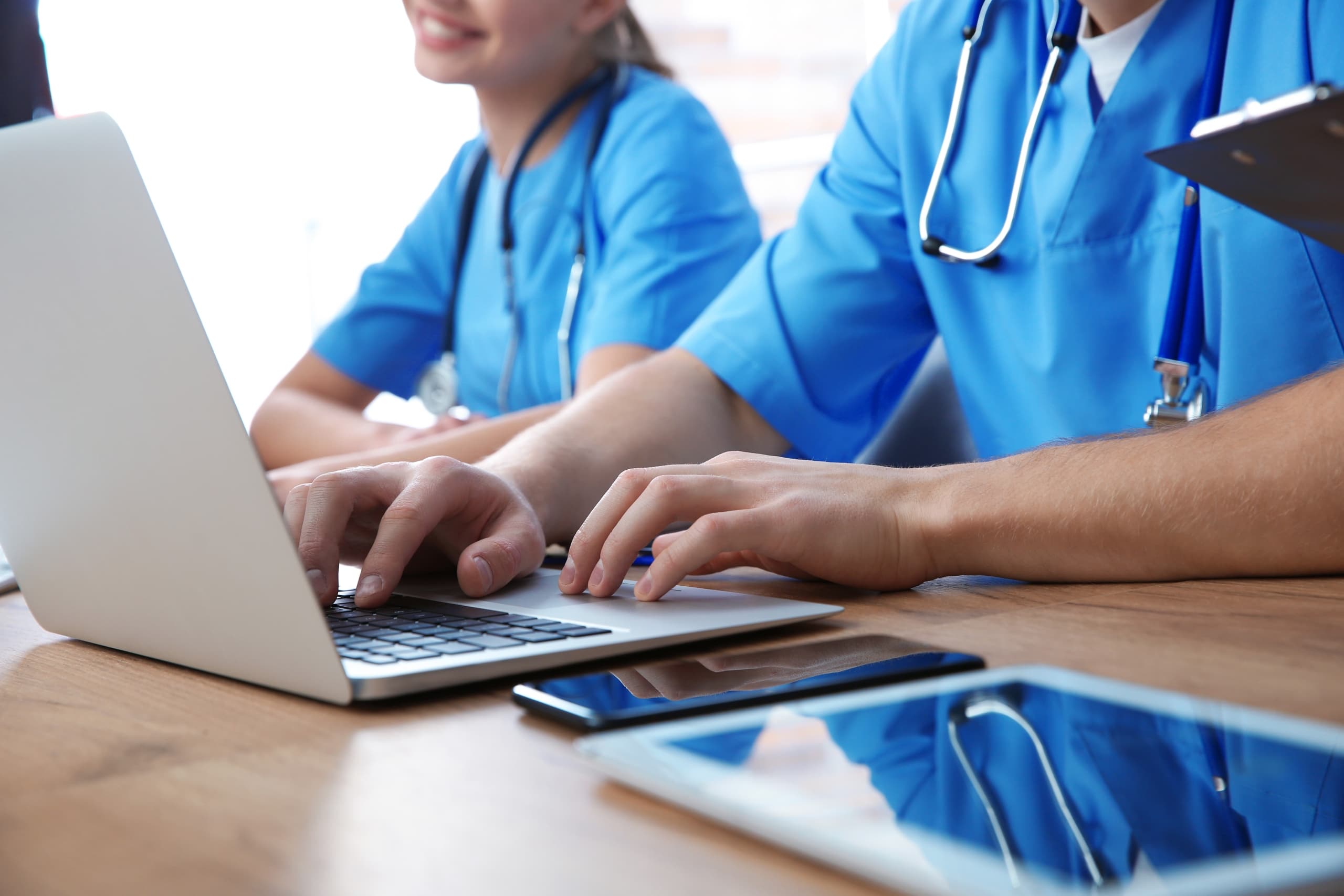 Close up of medical students typing on laptops