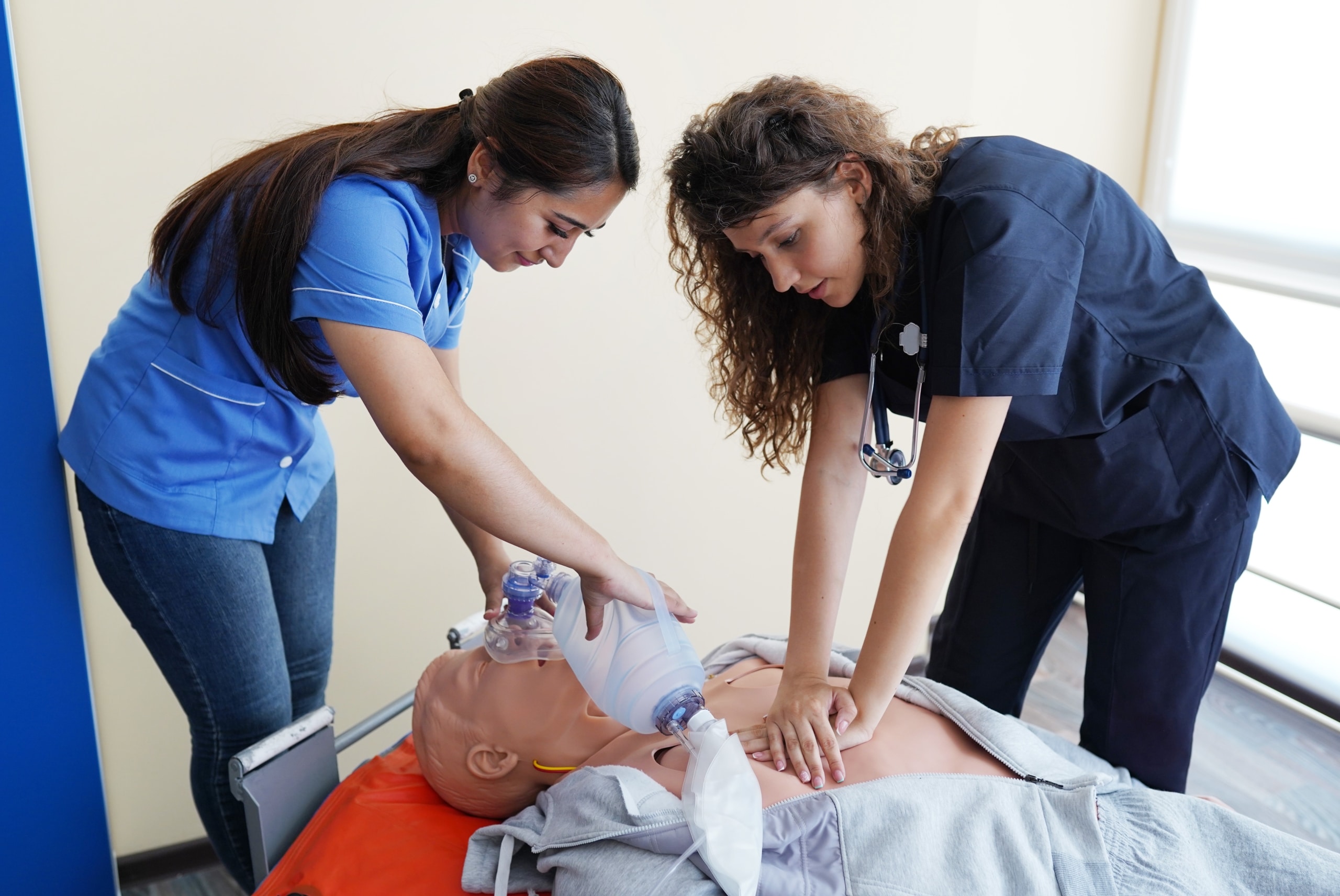 Medical students performing CPR on a mannequin