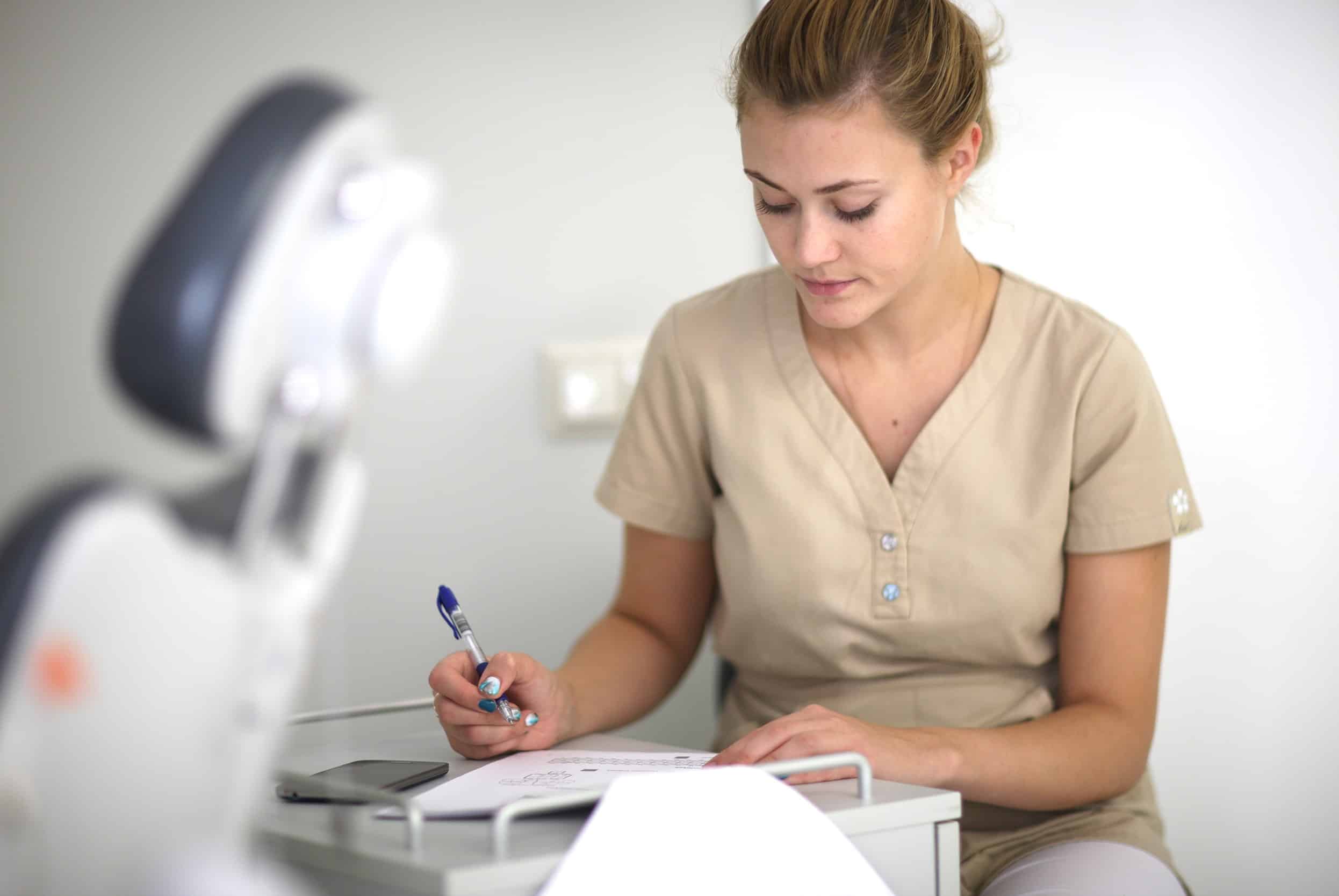 Dental professional taking notes in a room