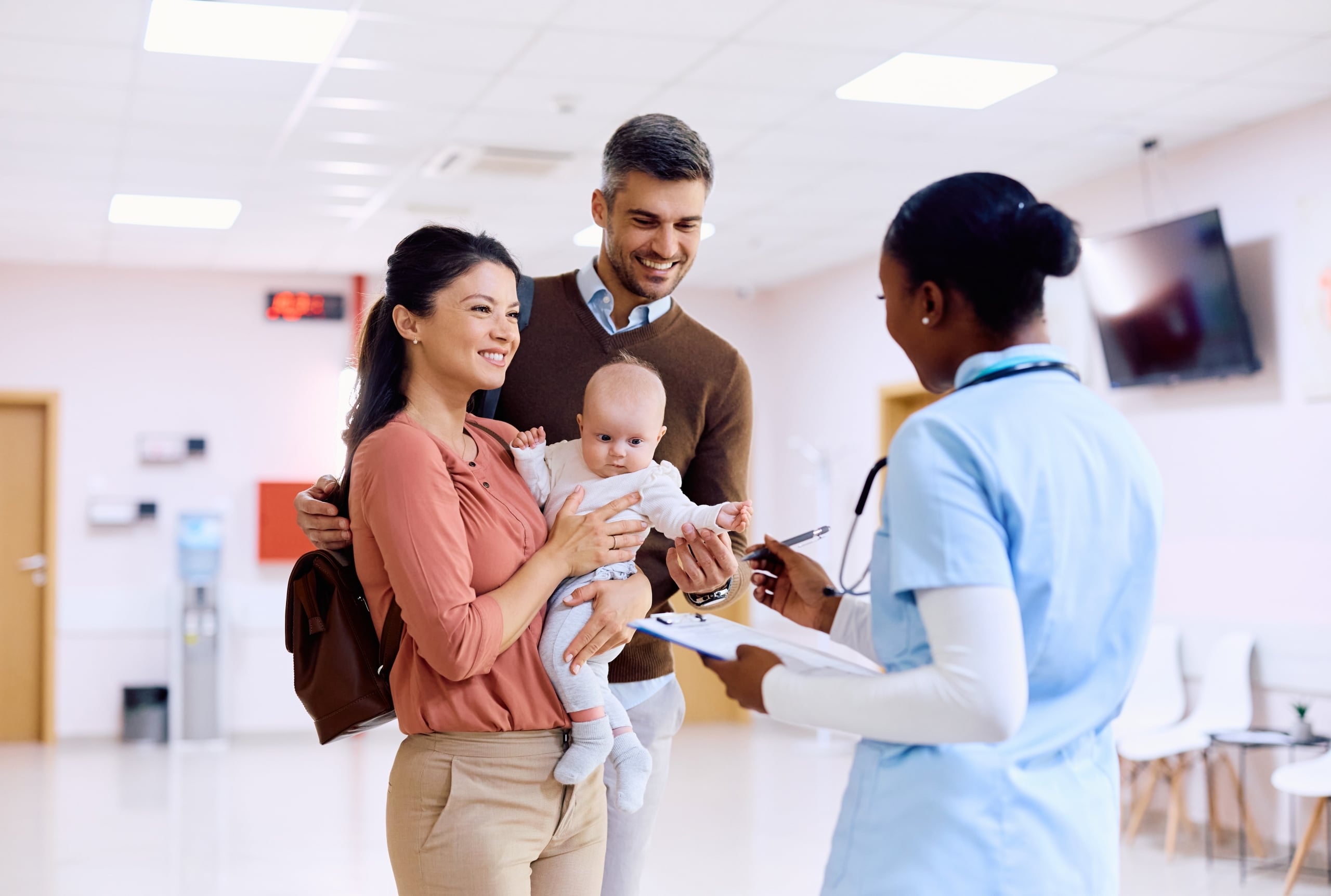 African-American nurse with an infant patient and their parents