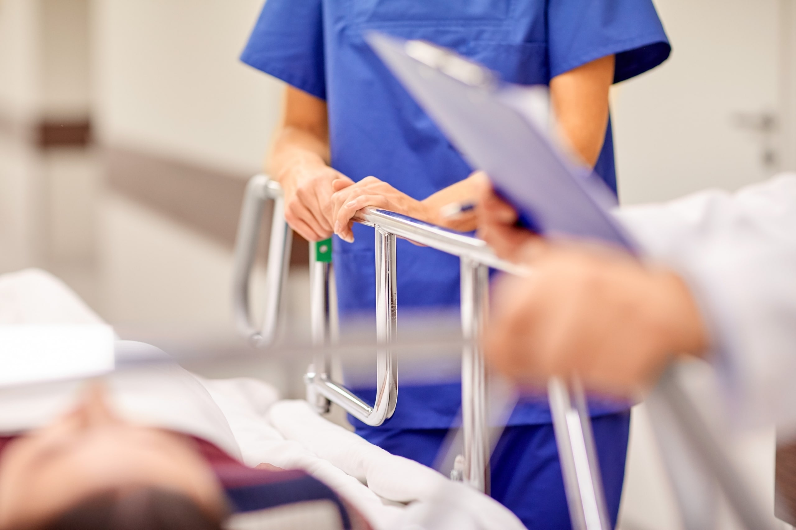 Close up of a nurse at a patient's bedside