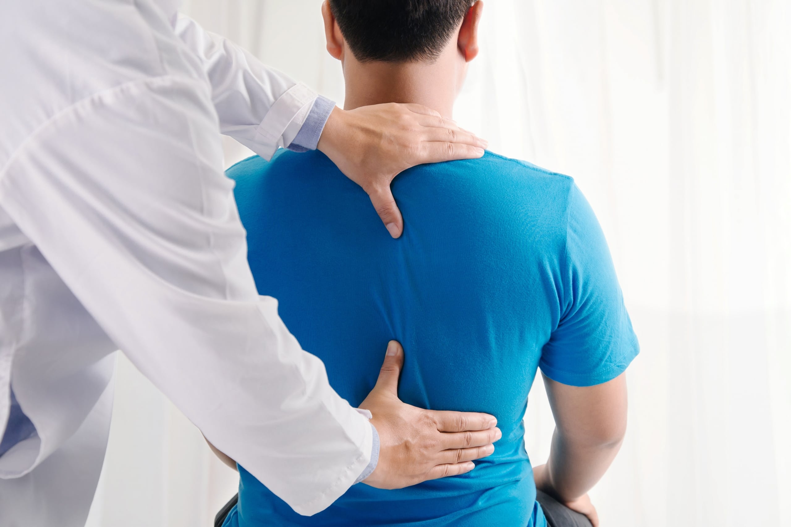 Medical professional treating a man for back pain