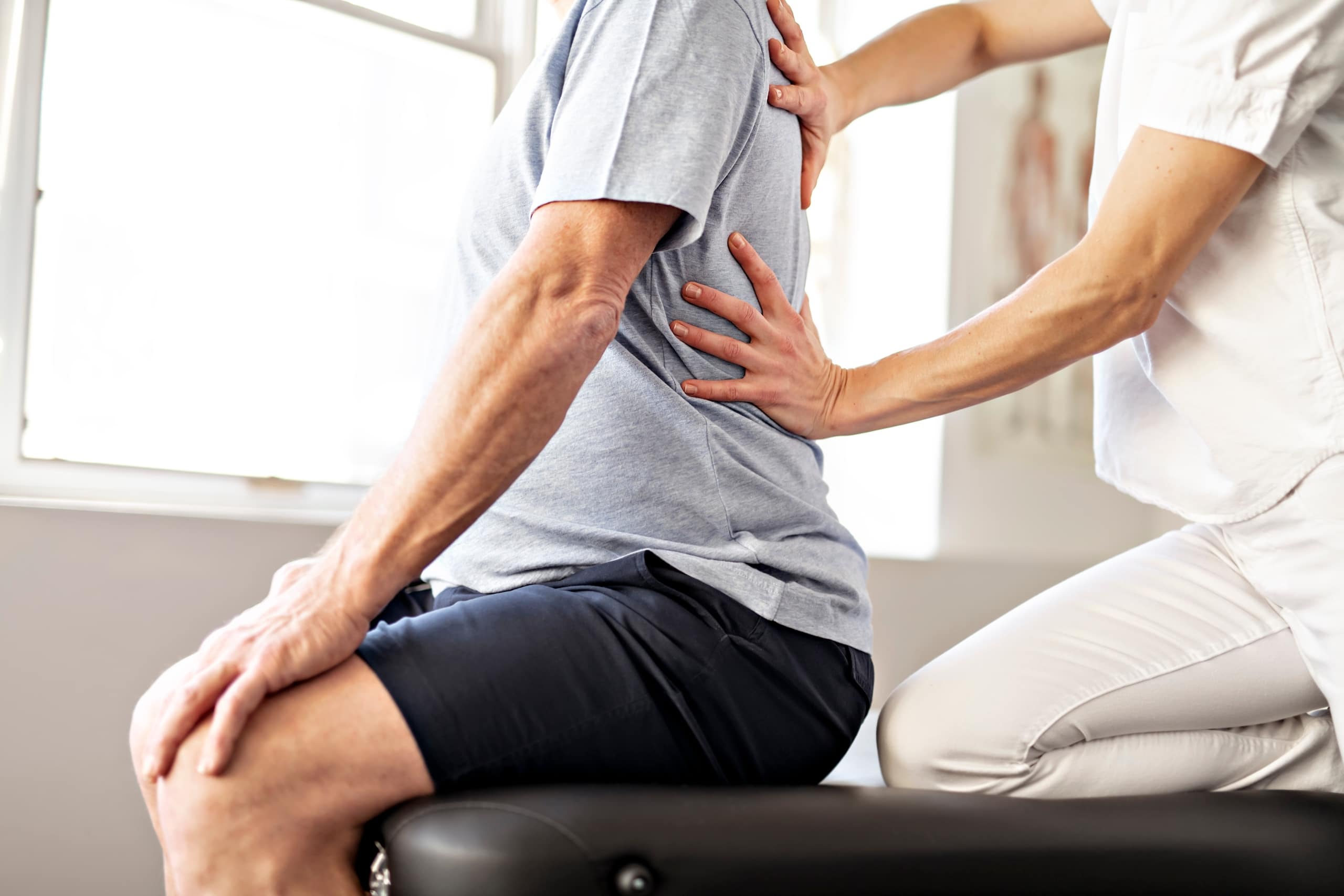 Close up of a physical therapy professional with an older client