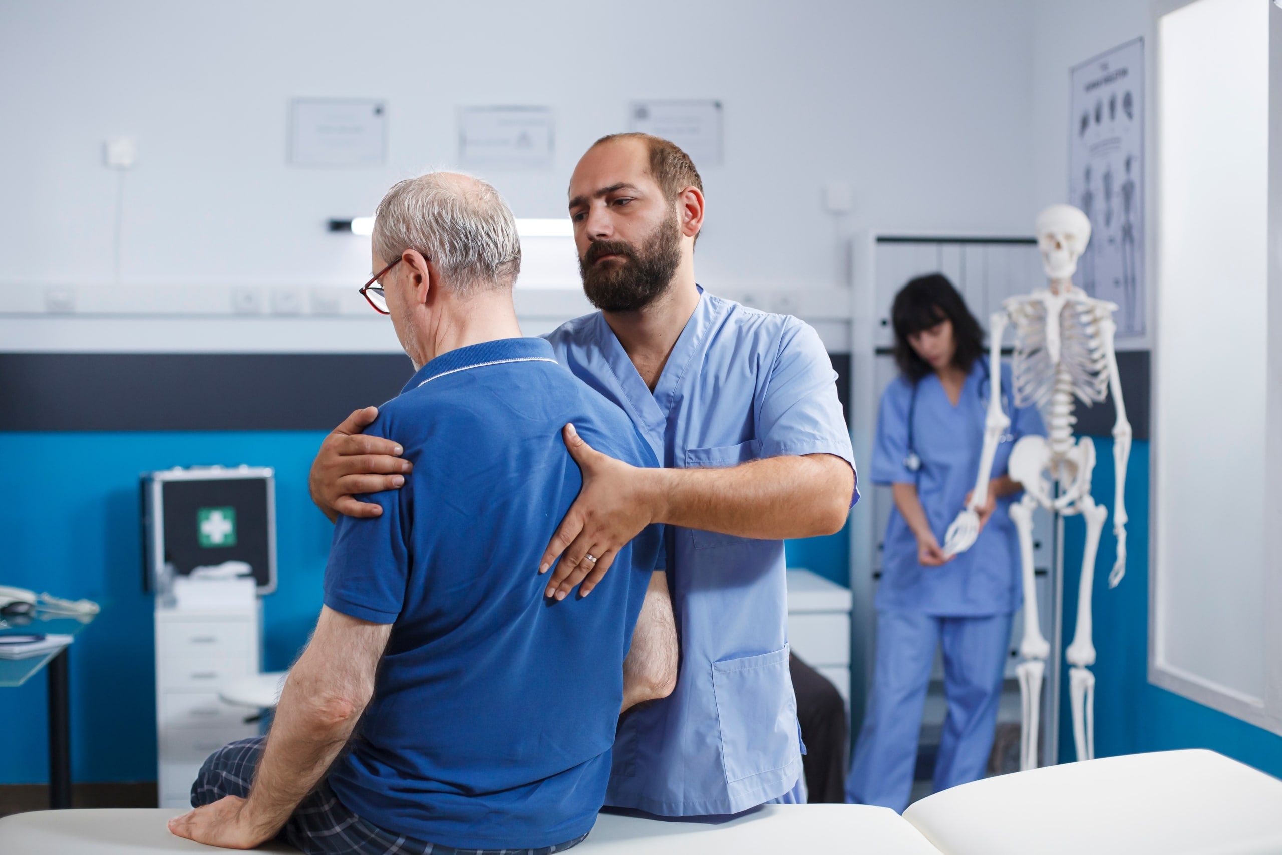 Physical therapy professional helping a patient with back discomfort