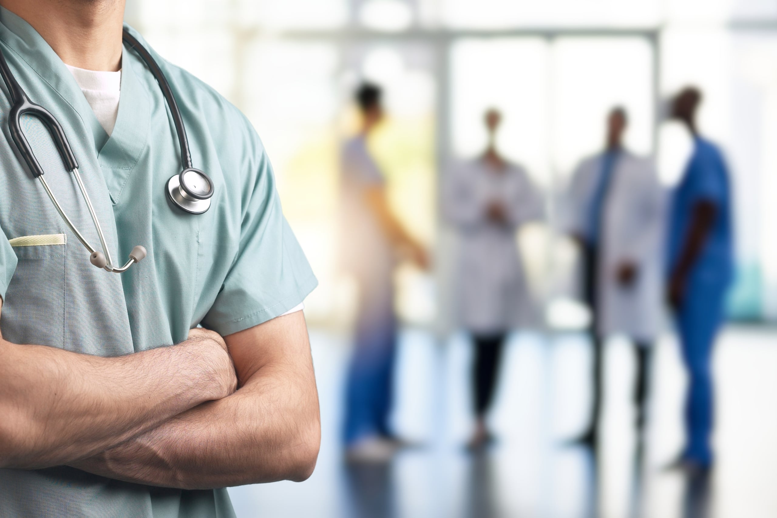 Close up of a medical professional with their arms crossed