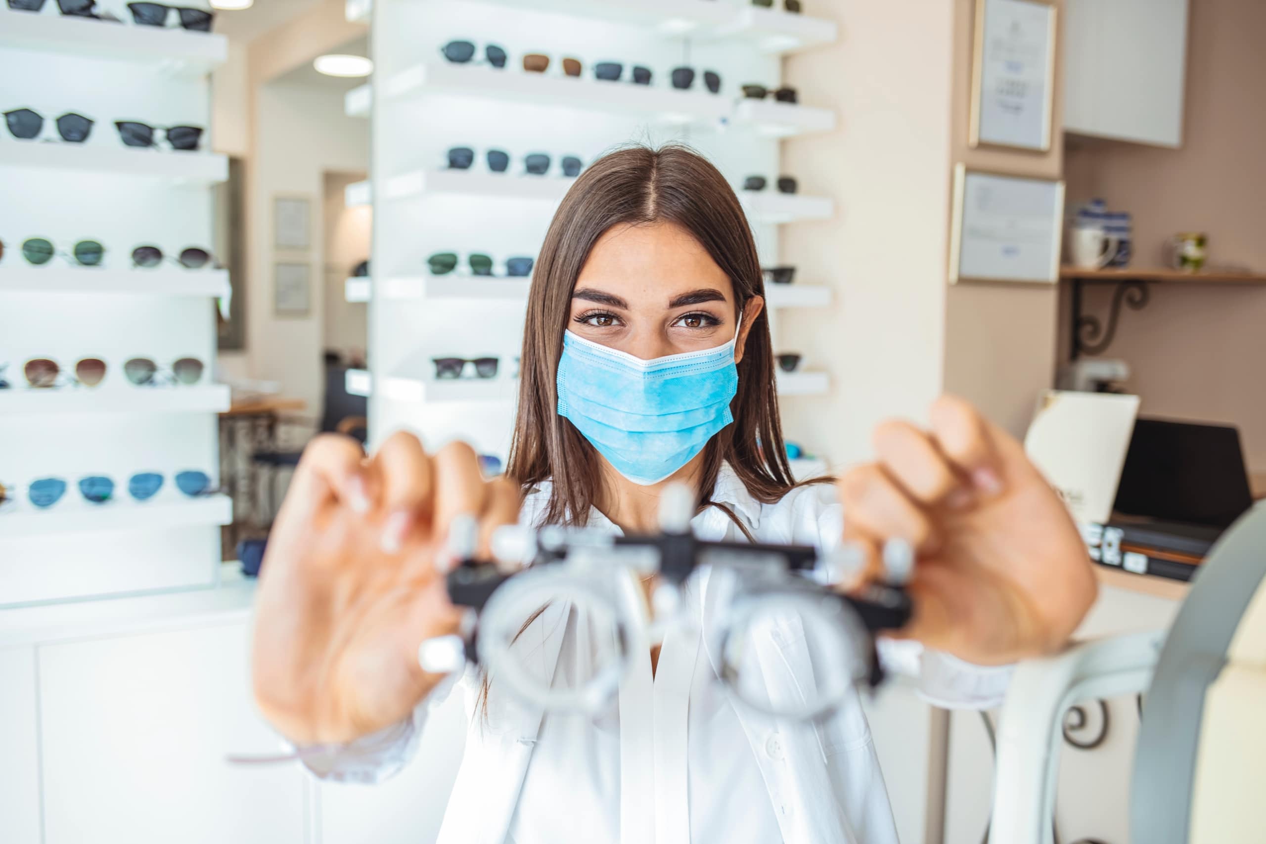 Female professional wearing a mask in an ophthalmologist office