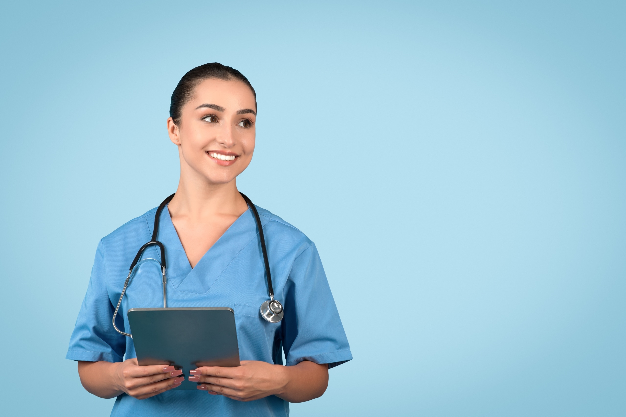 Cheerful young medical professional in blue scrubs