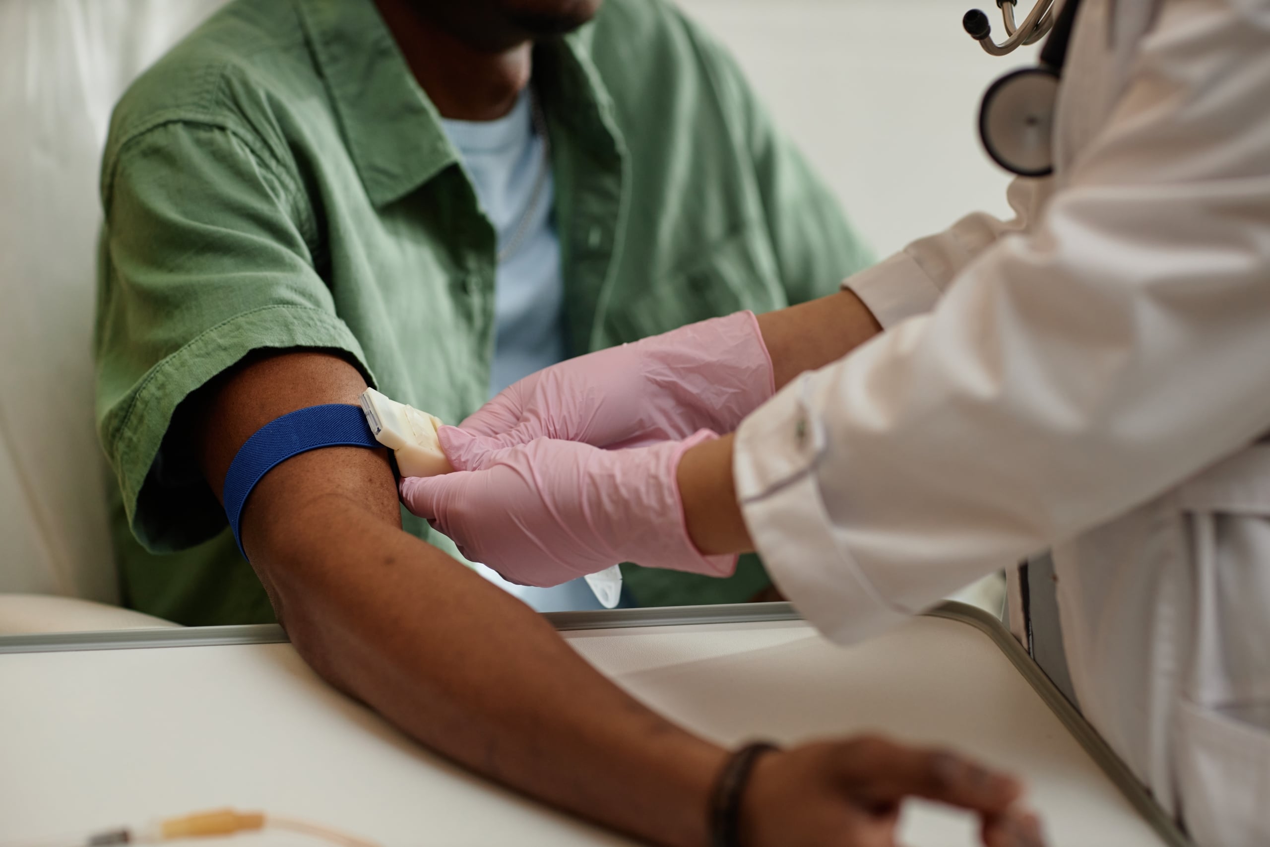 Close up of a medical professional preparing to draw blood from a patient
