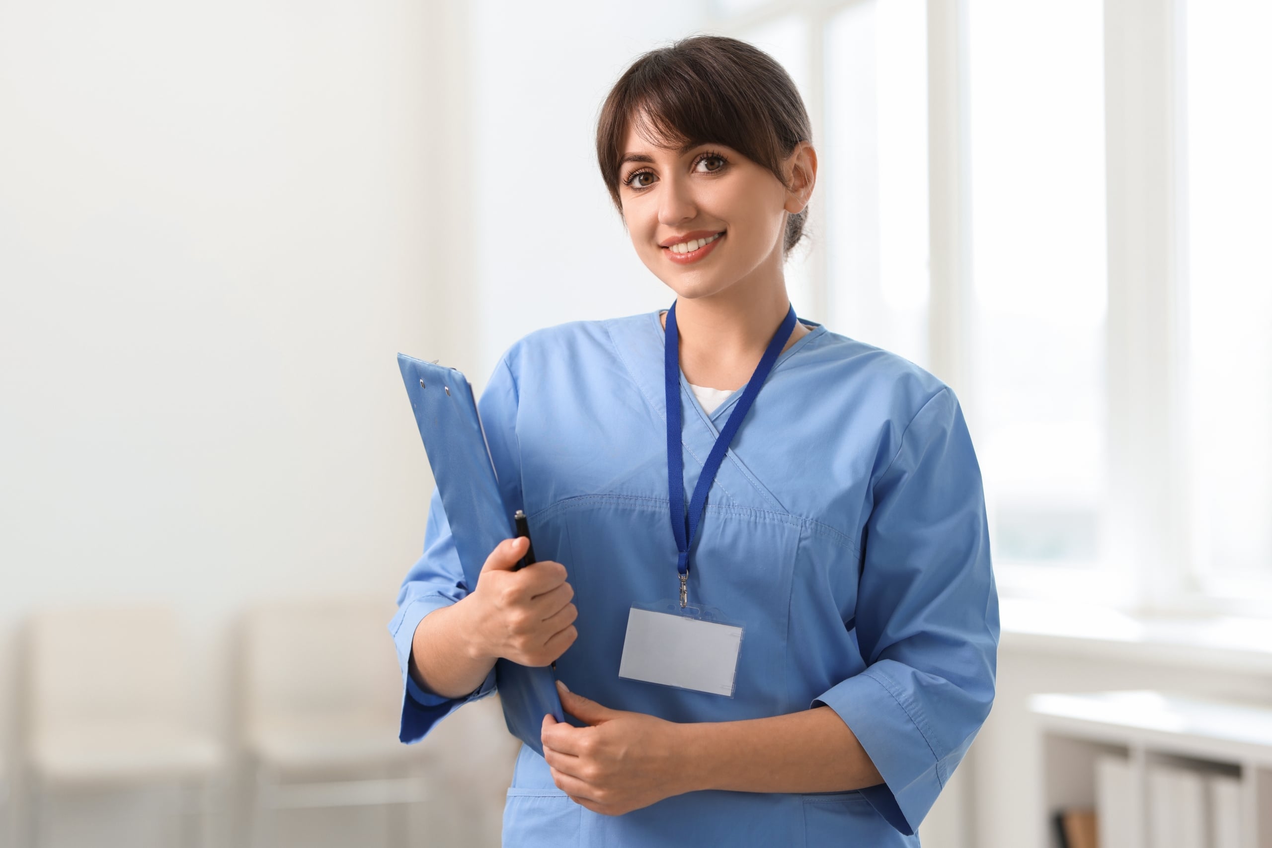 Portrait of a smiling medical professional holding a clipboard
