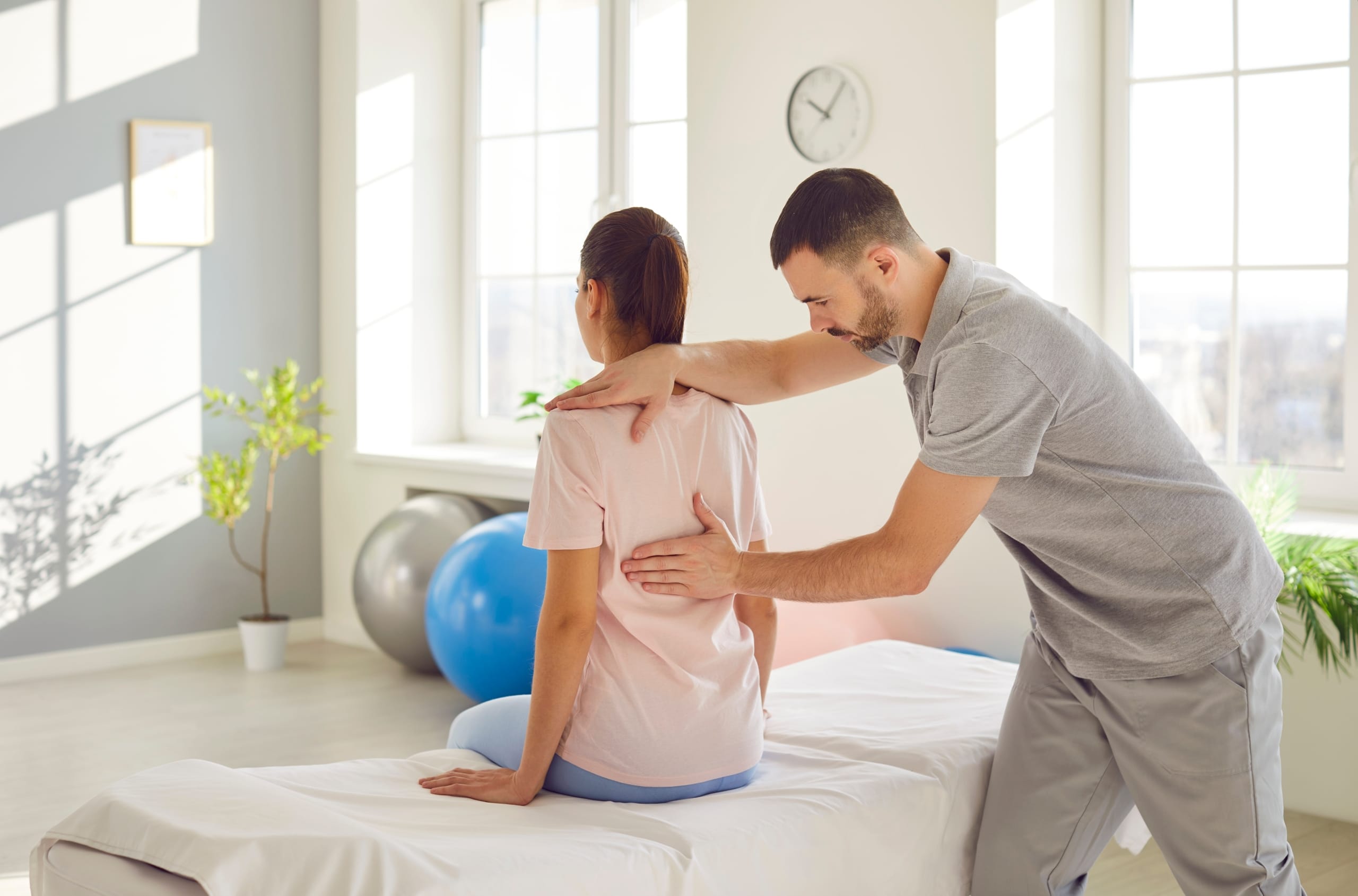 Chiropractic professional examining a female patient