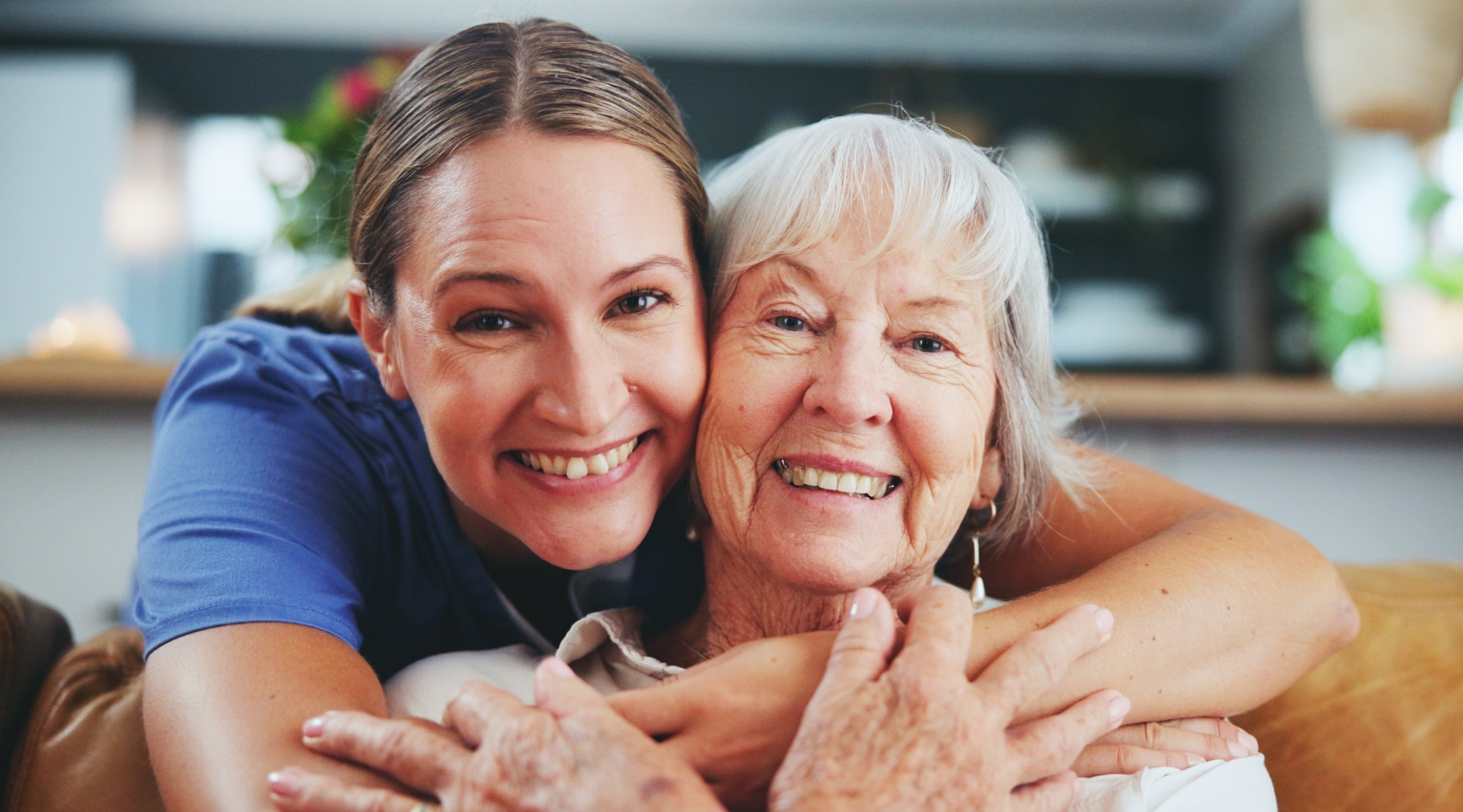 Close up of a medical professional hugging a senior patient