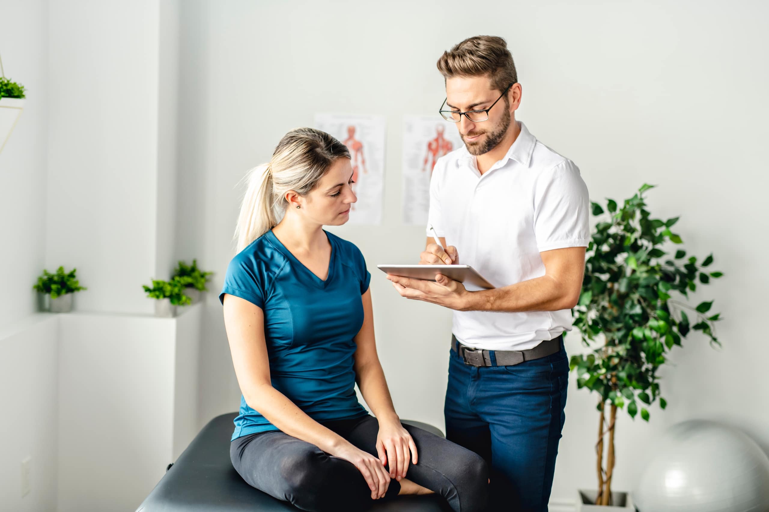 Woman in a physiotherapy clinic with a physical therapist assistant