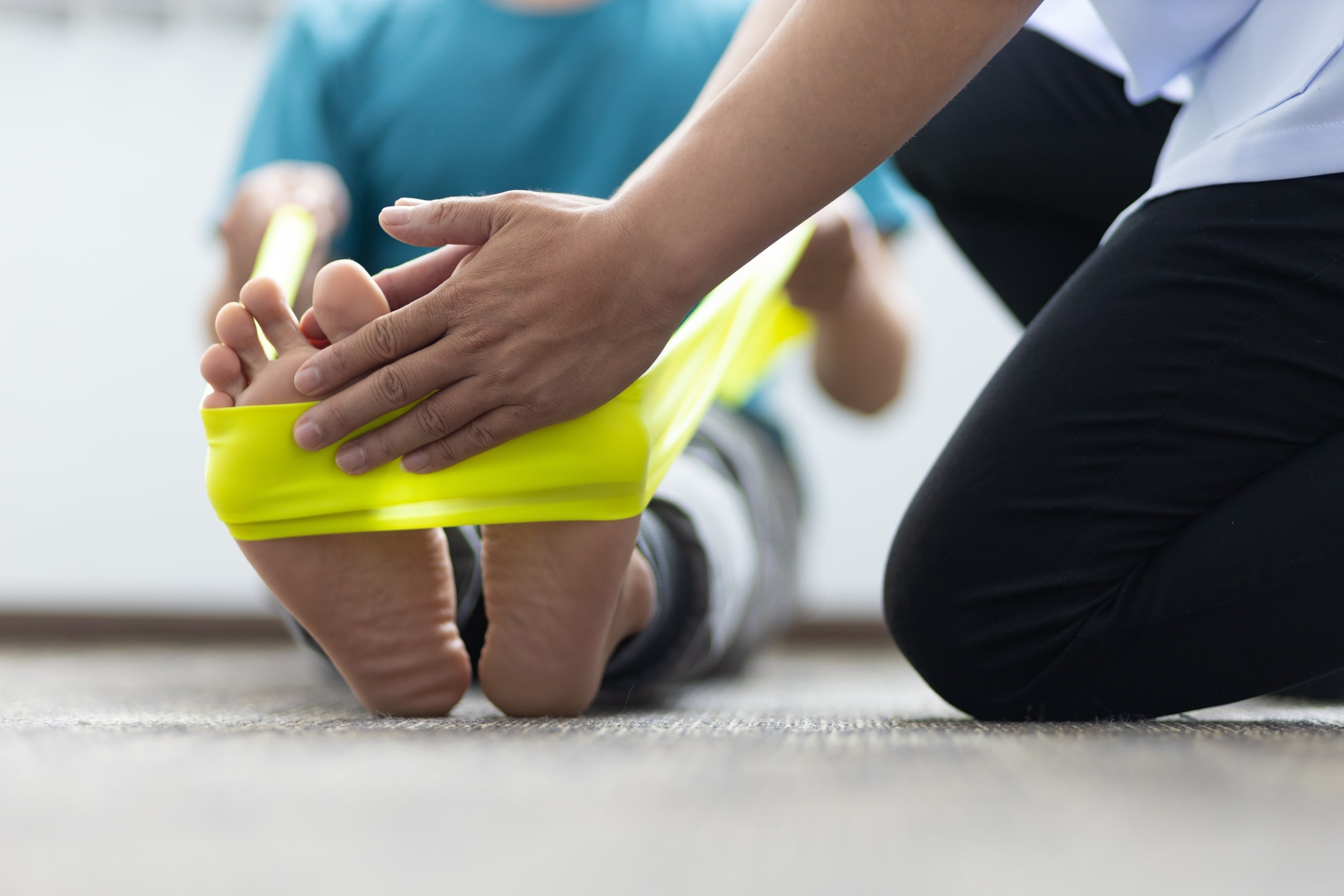 Close up of a physiotherapy patient using an exercise band