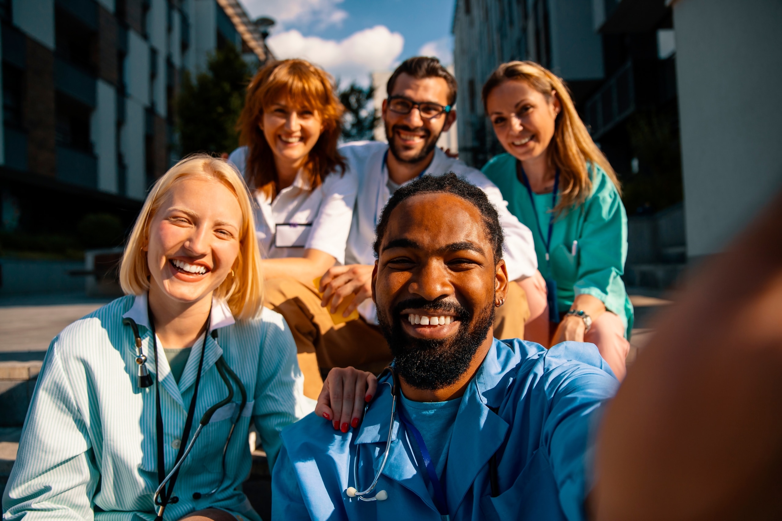 Diverse medical professionals taking a selfie outside