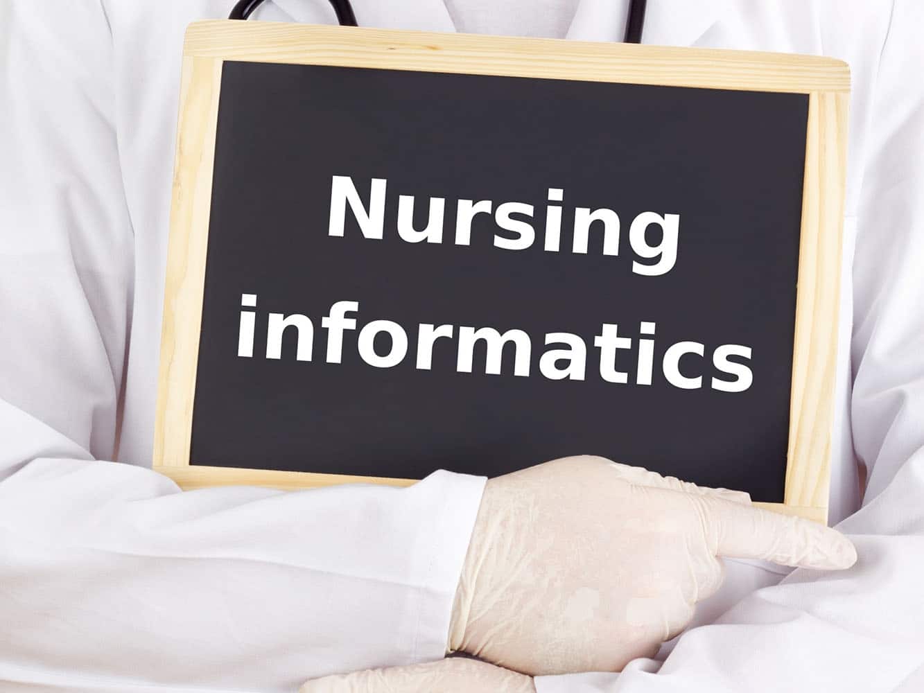 Medical professional holding a sign that says nursing informatics