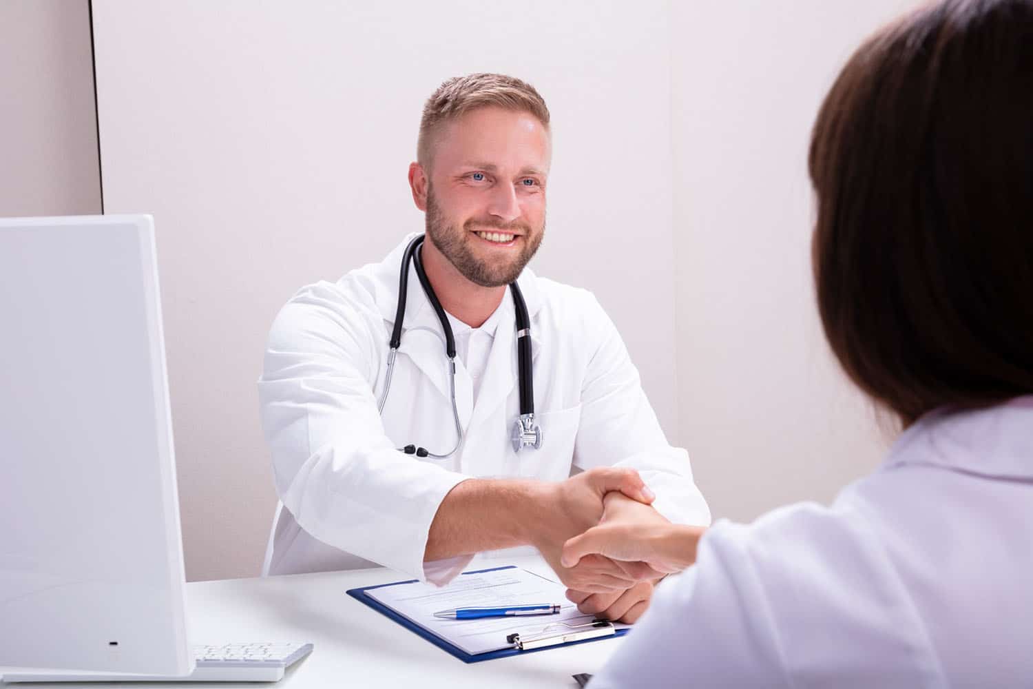 Male recruiter shaking hands with a medical professional